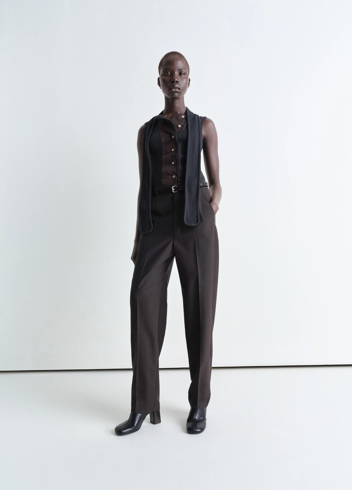 Lemaire belted tailored pants in mottled tropical poly-wool, model shot, front view straight cut tapered leg