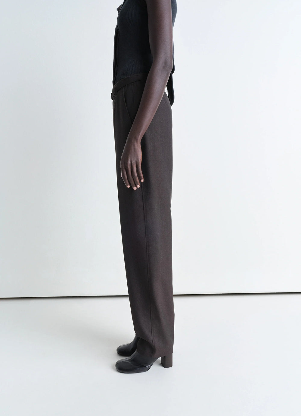 Lemaire Belted Tailored Pants in Mottled Tropical Poly-Wool, model shot, side view loose fit drape