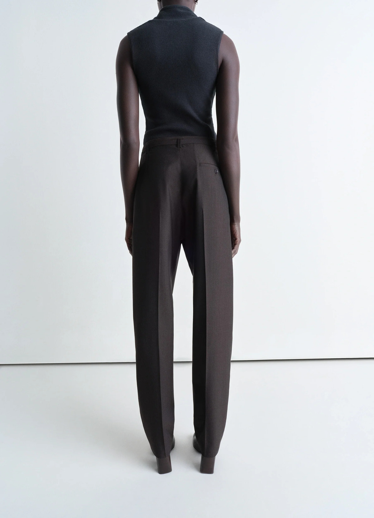 Lemaire belted tailored pants in mottled tropical poly-wool, model shot, back view loose fit high waist