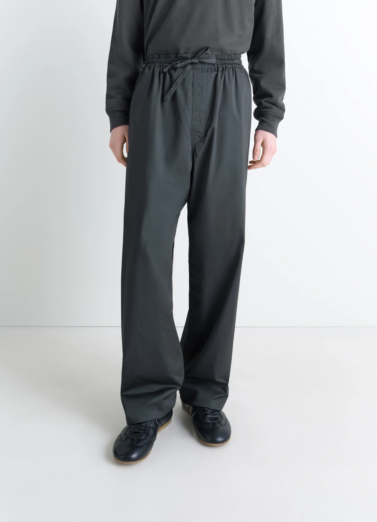 Lemaire pyjama pants in garment dyed satin, model shot, three-quarter front view elastic waistband detail