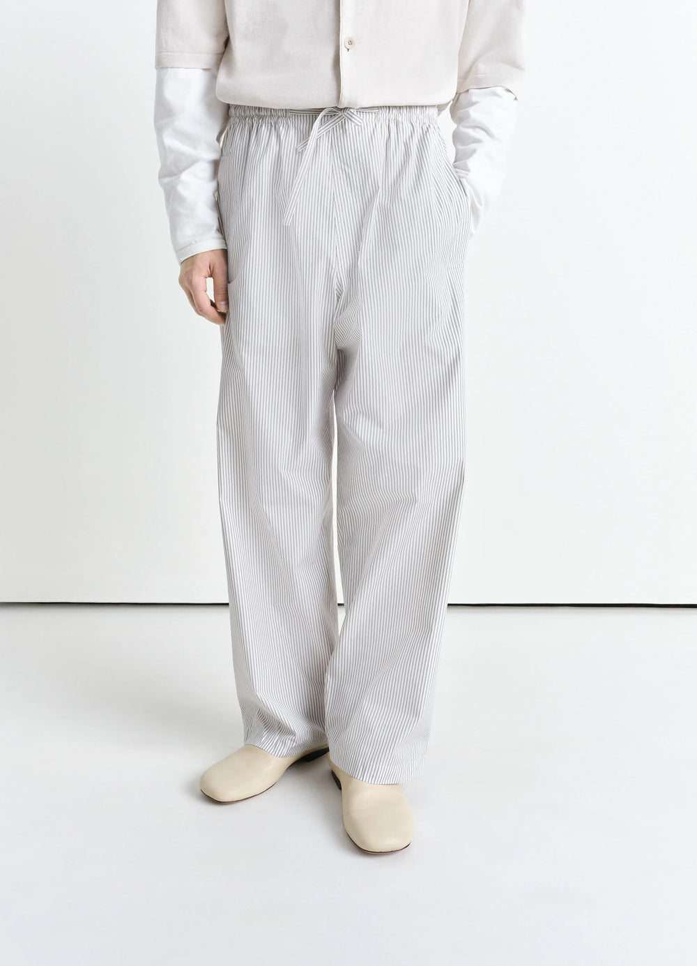 Lemaire Pyjama Pants in Striped Cotton Poplin, model shot, side view elastic waist with pockets