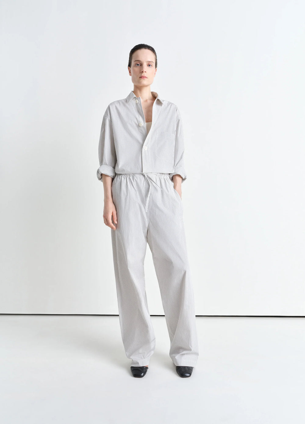Lemaire Pyjama Pants in Striped Cotton Poplin, model shot, three-quarter view loose fit, cuffed hem