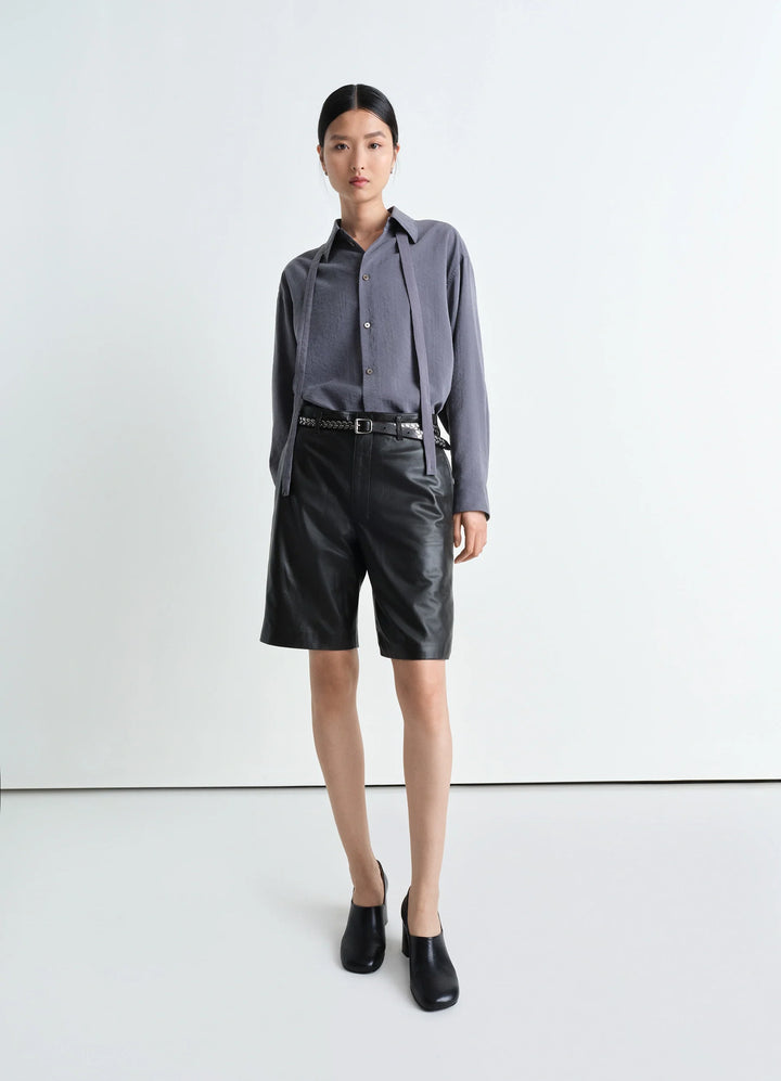 Lemaire Leather Shorts in Mat Black Leather, model shot, front view slightly flared knee-length