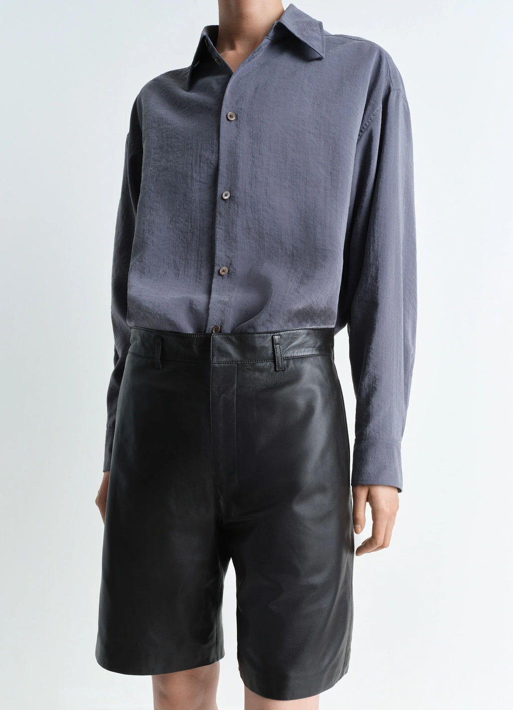 Lemaire Leather Shorts in Mat Black Leather, model shot, side angle high waist belt loops