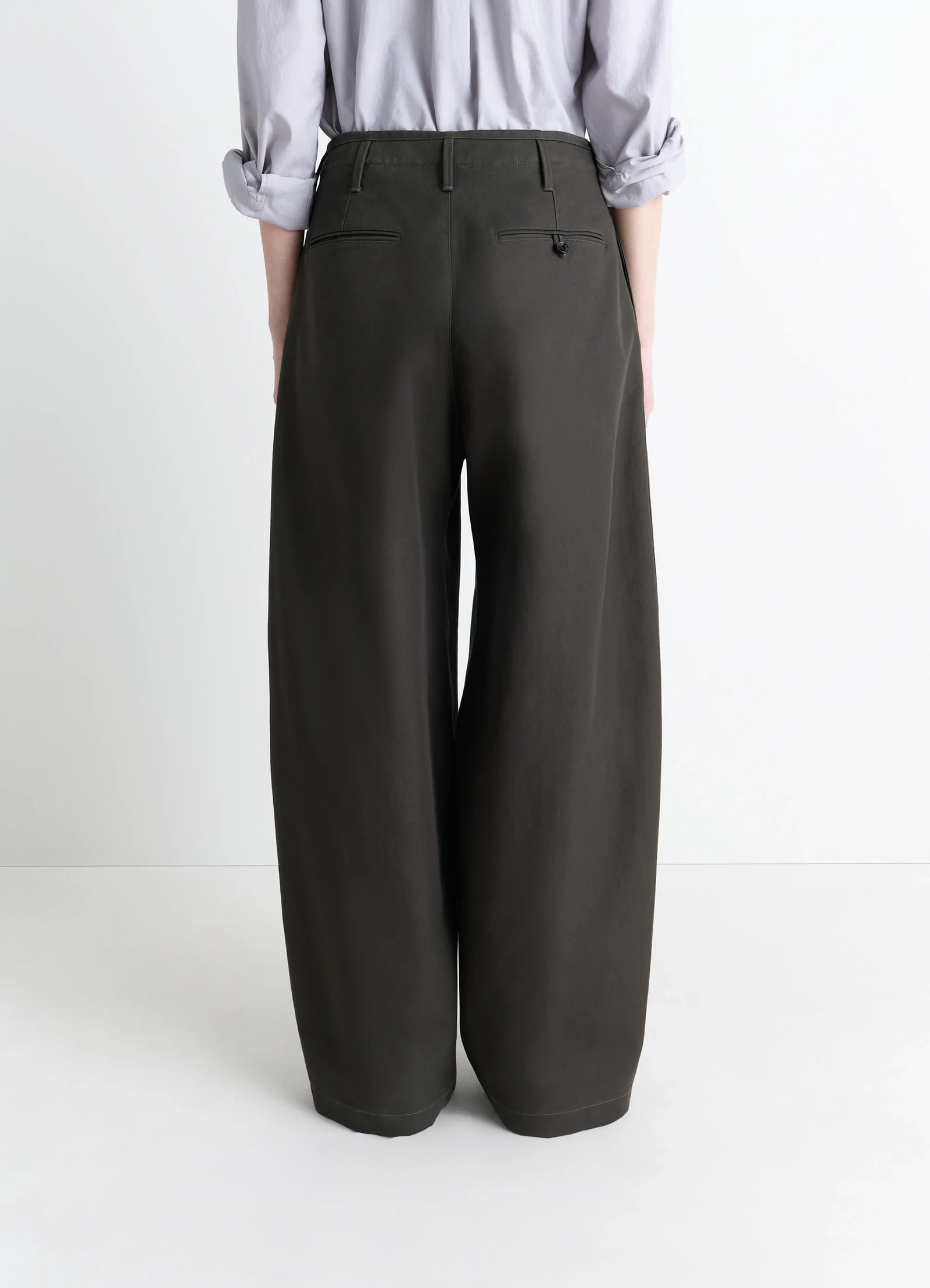 Lemaire large chino pants in dark olive cotton twill, model shot, back view belt loops, rear welt pockets