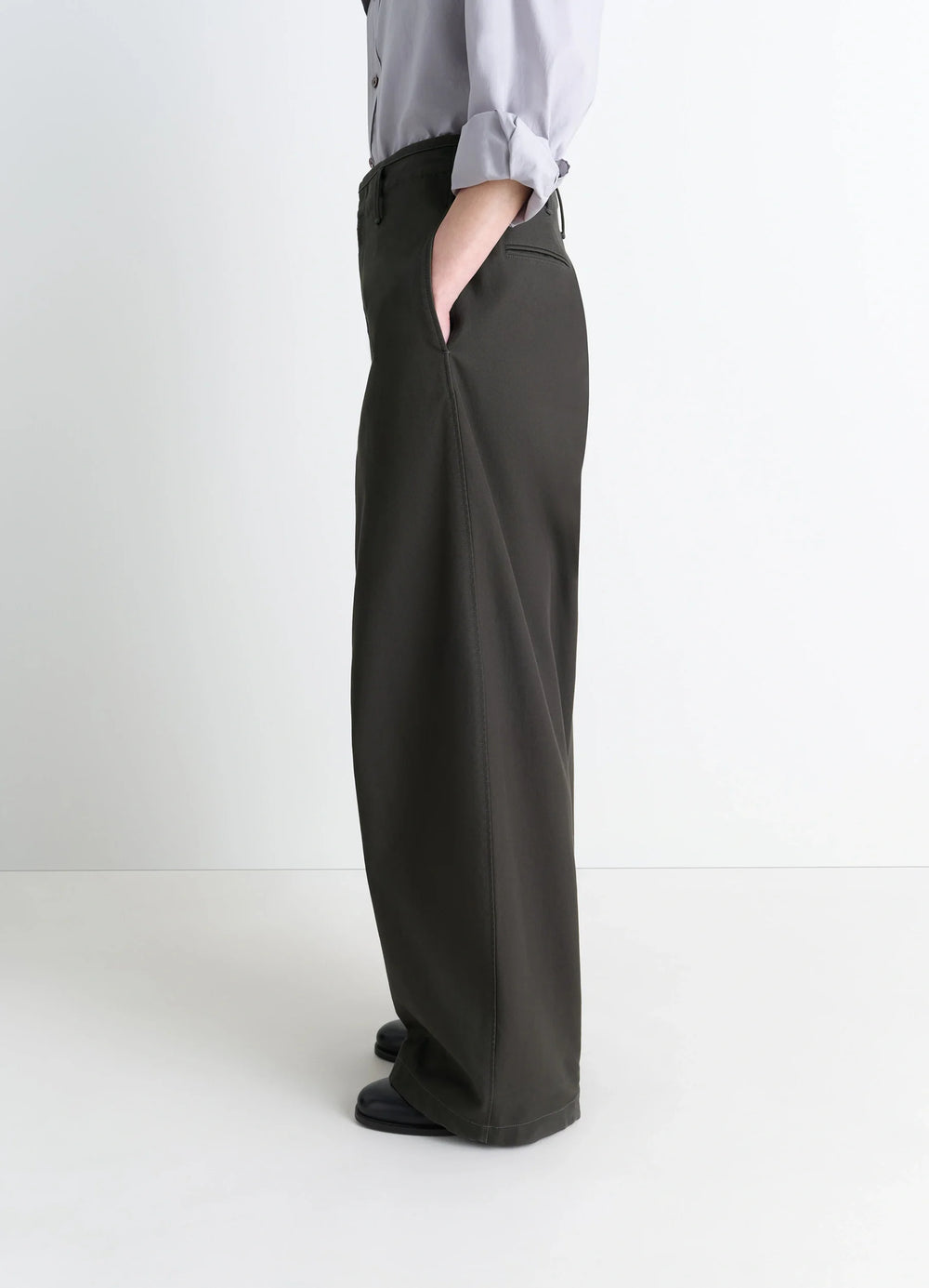 Lemaire Large Chino Pants in Dark Olive Cotton Twill, model shot, three-quarter rear view oversized with side pockets