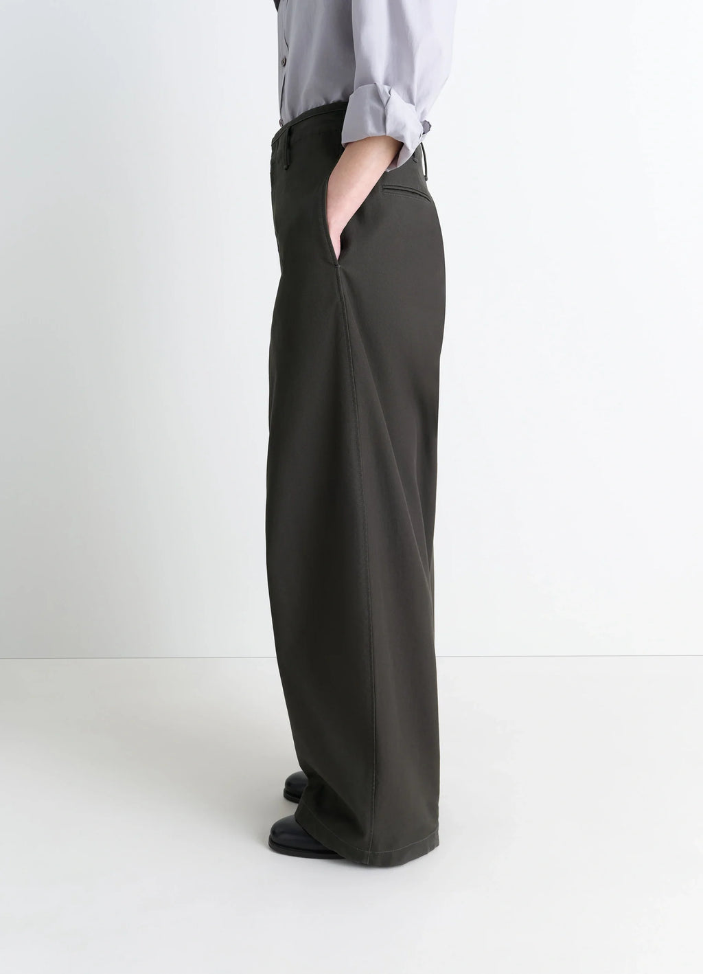 Lemaire Large Chino Pants in Dark Olive Cotton Twill, model shot, three-quarter rear view oversized with side pockets