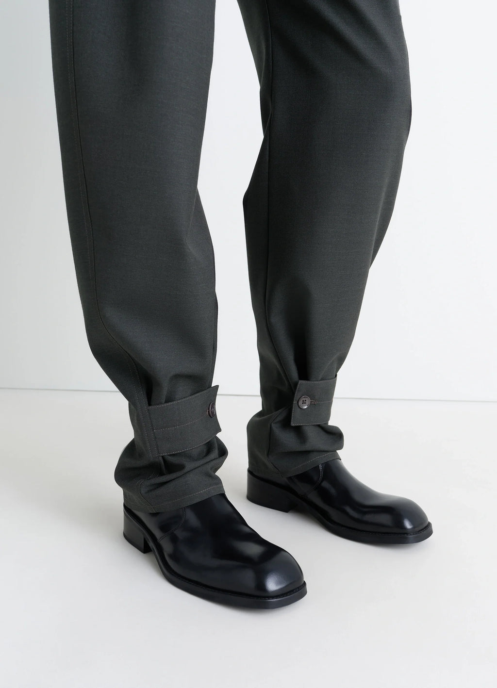 Lemaire Curved Tailored Pants in Tropical Wool Blend, model shot, bottom detail buttoned cuff hem