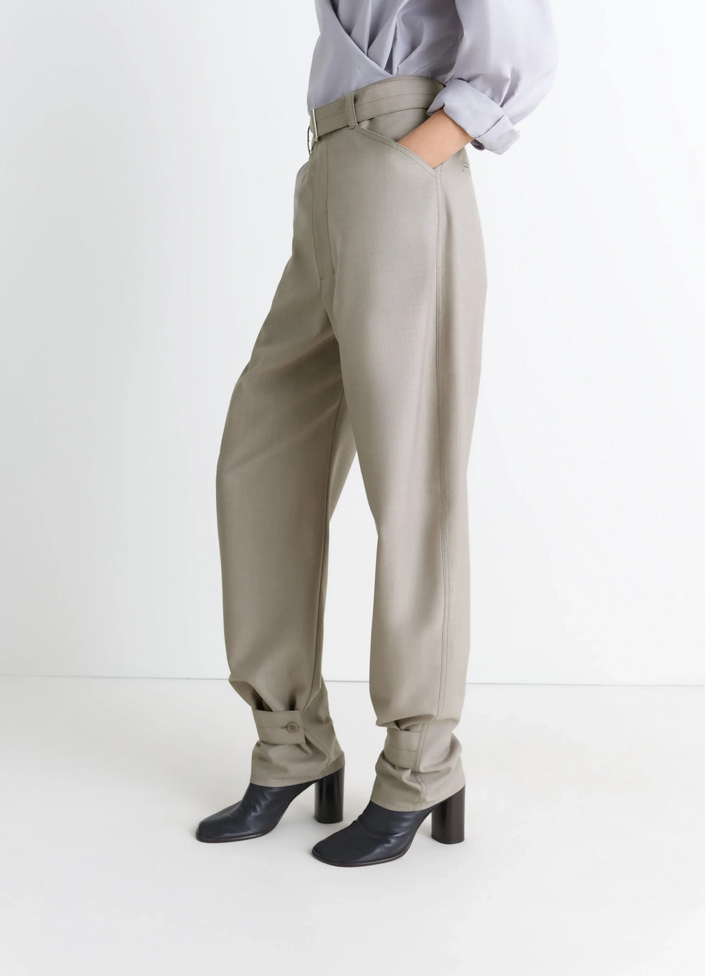 Lemaire Curved Tailored Pants in Tropical Wool Blend, model shot, three-quarter view high waist pleated pants