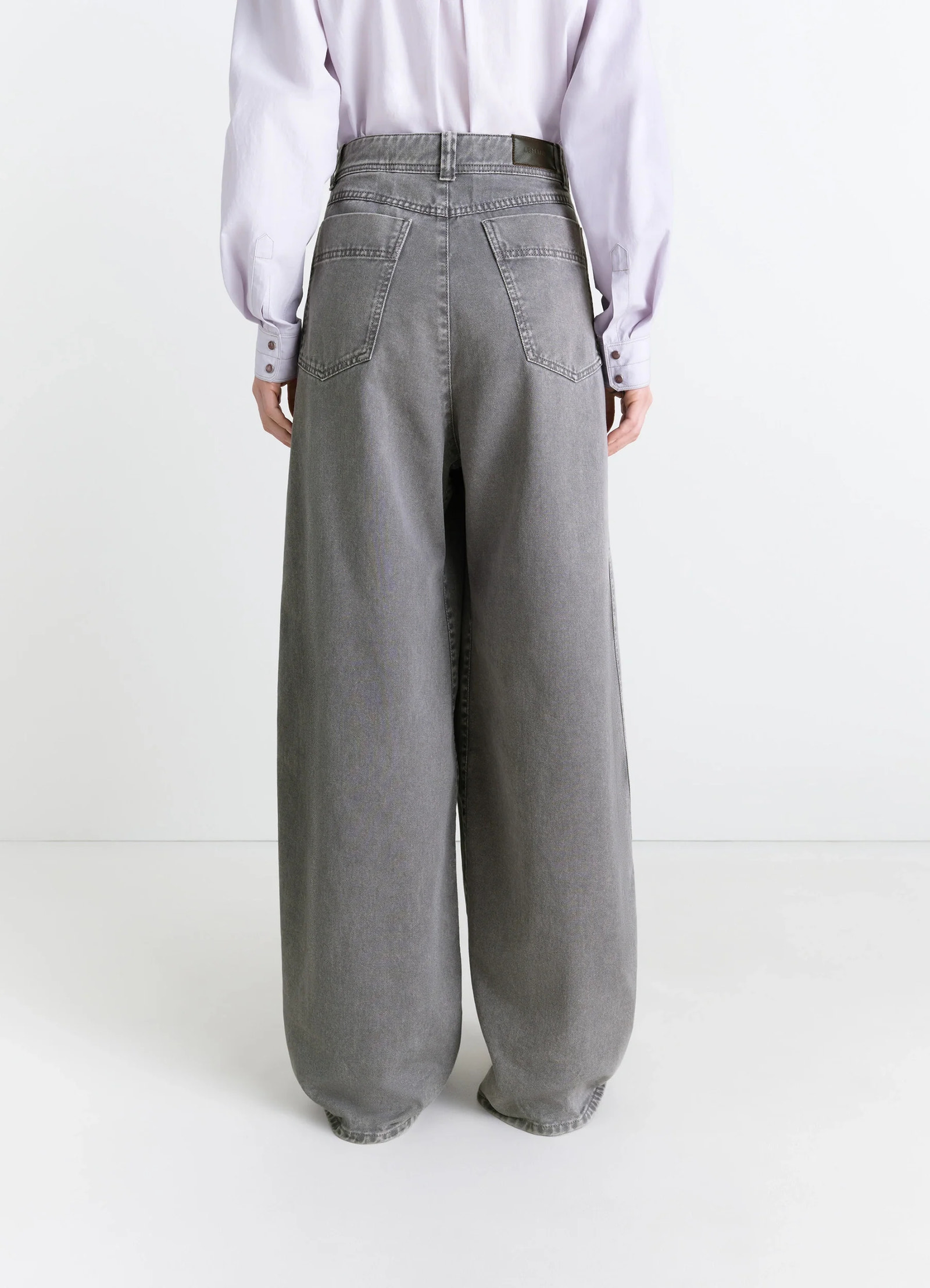 Lemaire wide leg pants in snow garment dyed denim, model shot, back view rear pockets, high waist