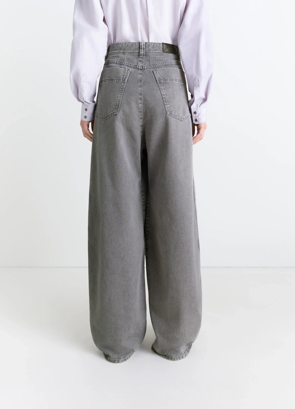 Lemaire Wide Leg Pants in Snow Garment Dyed Denim, model shot, back view rear pockets, high waist