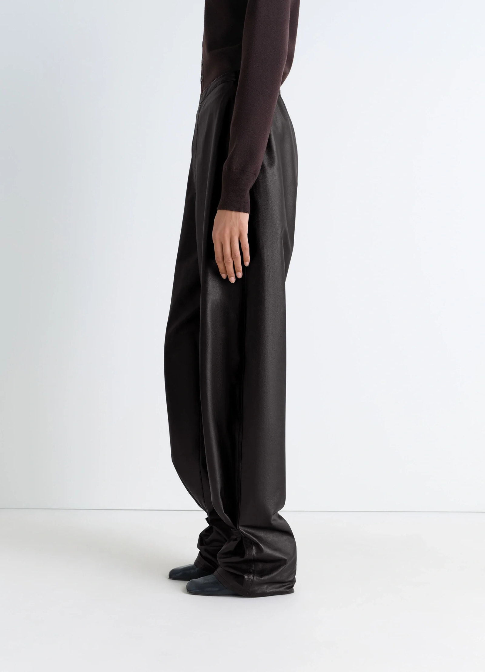Lemaire soft leather pants in cow leather with natural shine, model shot, side view high-waisted, relaxed fit