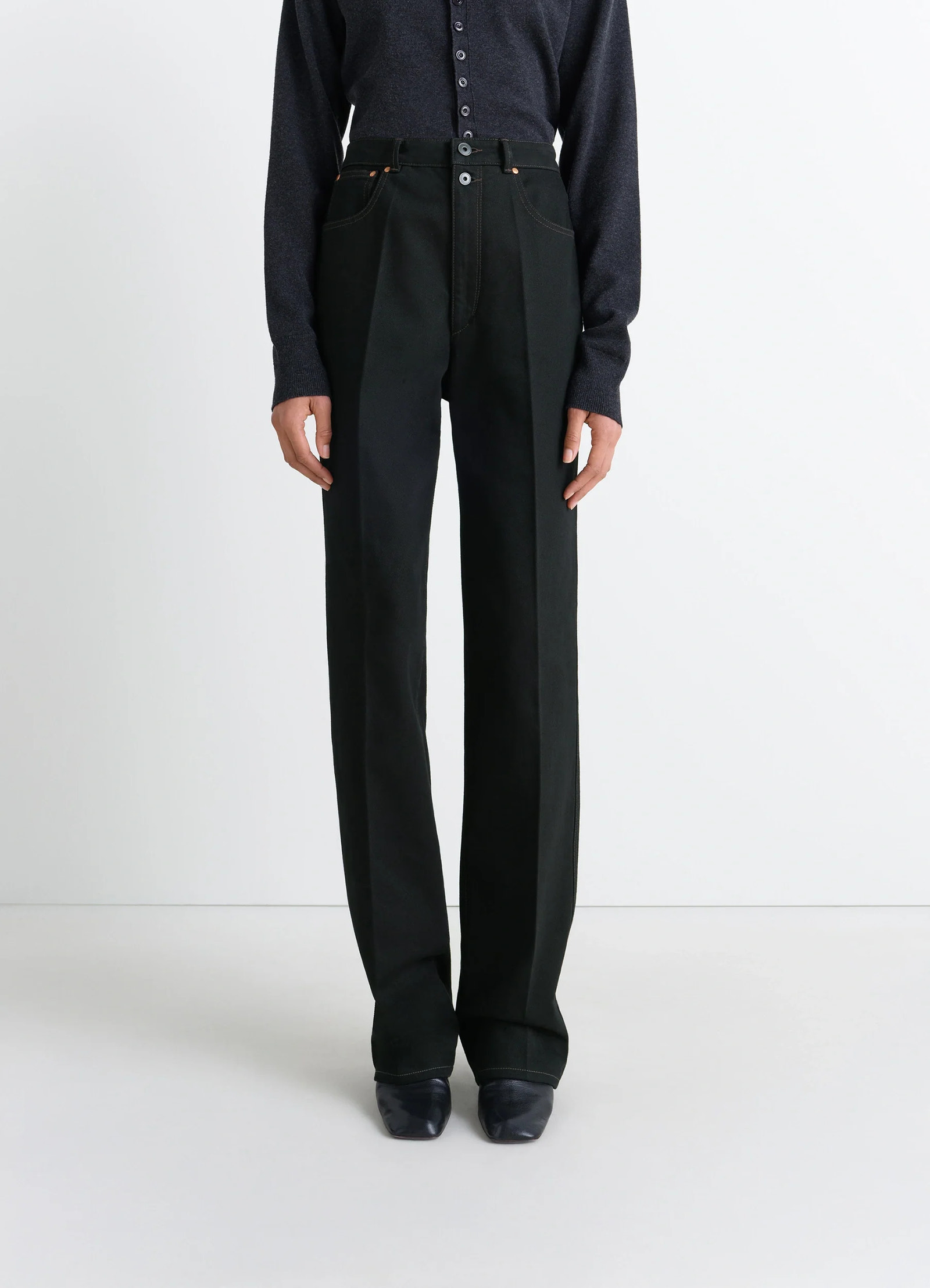 Lemaire high waisted straight pants in deep black thick denim, model shot, 3/4 view high waist with button details