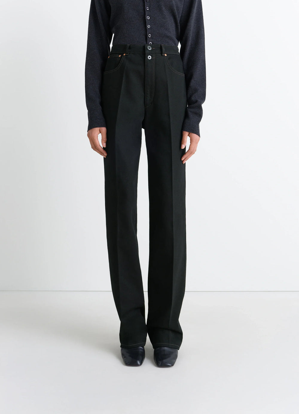 Lemaire High Waisted Straight Pants in Deep Black Thick Denim, model shot, 3/4 view high waist with button details