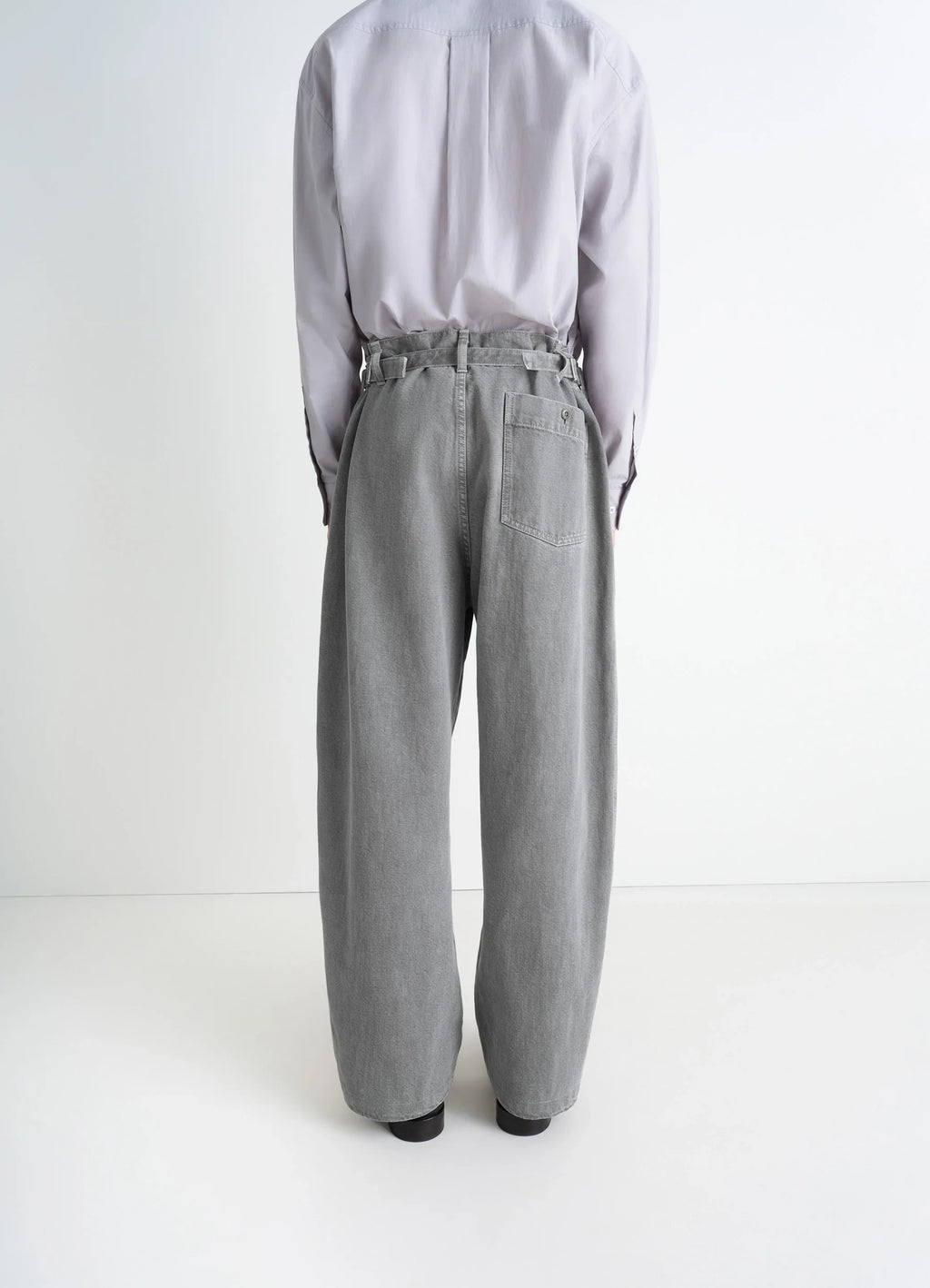 Lemaire Maxi Workwear Pants in Heather Garment Dyed Snow Heavy Den, model shot, rear full body view high waist, buttoned back