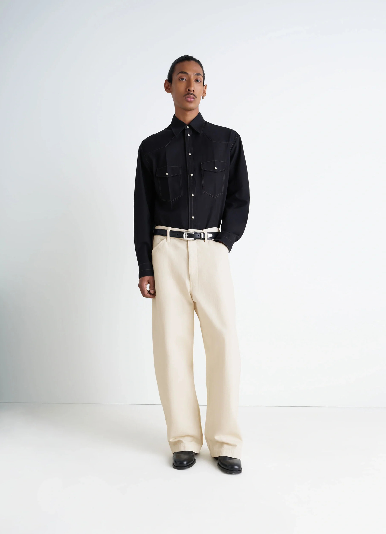 Lemaire maxi workwear pants in heather garment dyed denim, model shot, front view oversized, wide leg