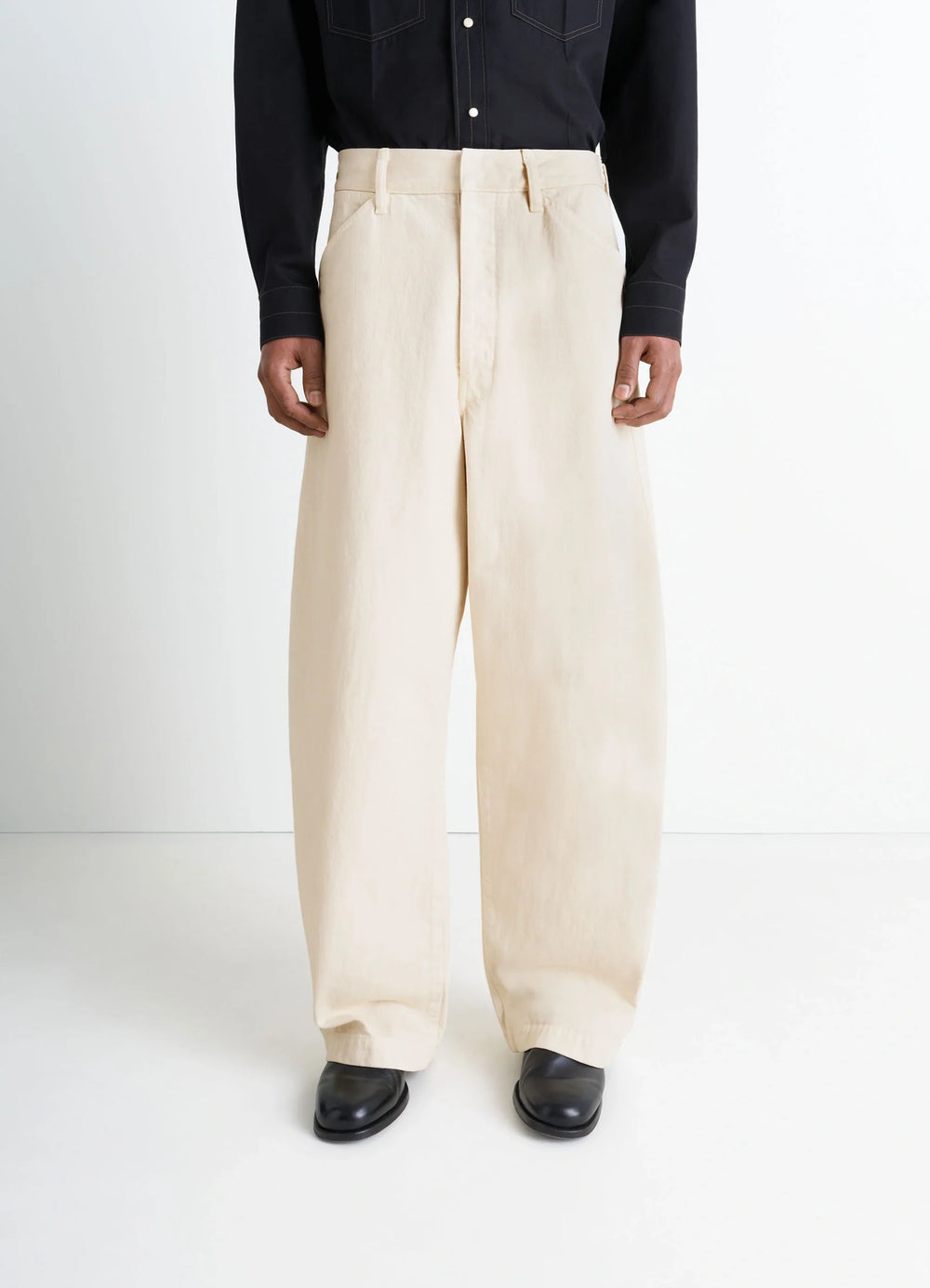 Lemaire Maxi Workwear Pants in Heather Garment Dyed Denim, model shot, back view high waist