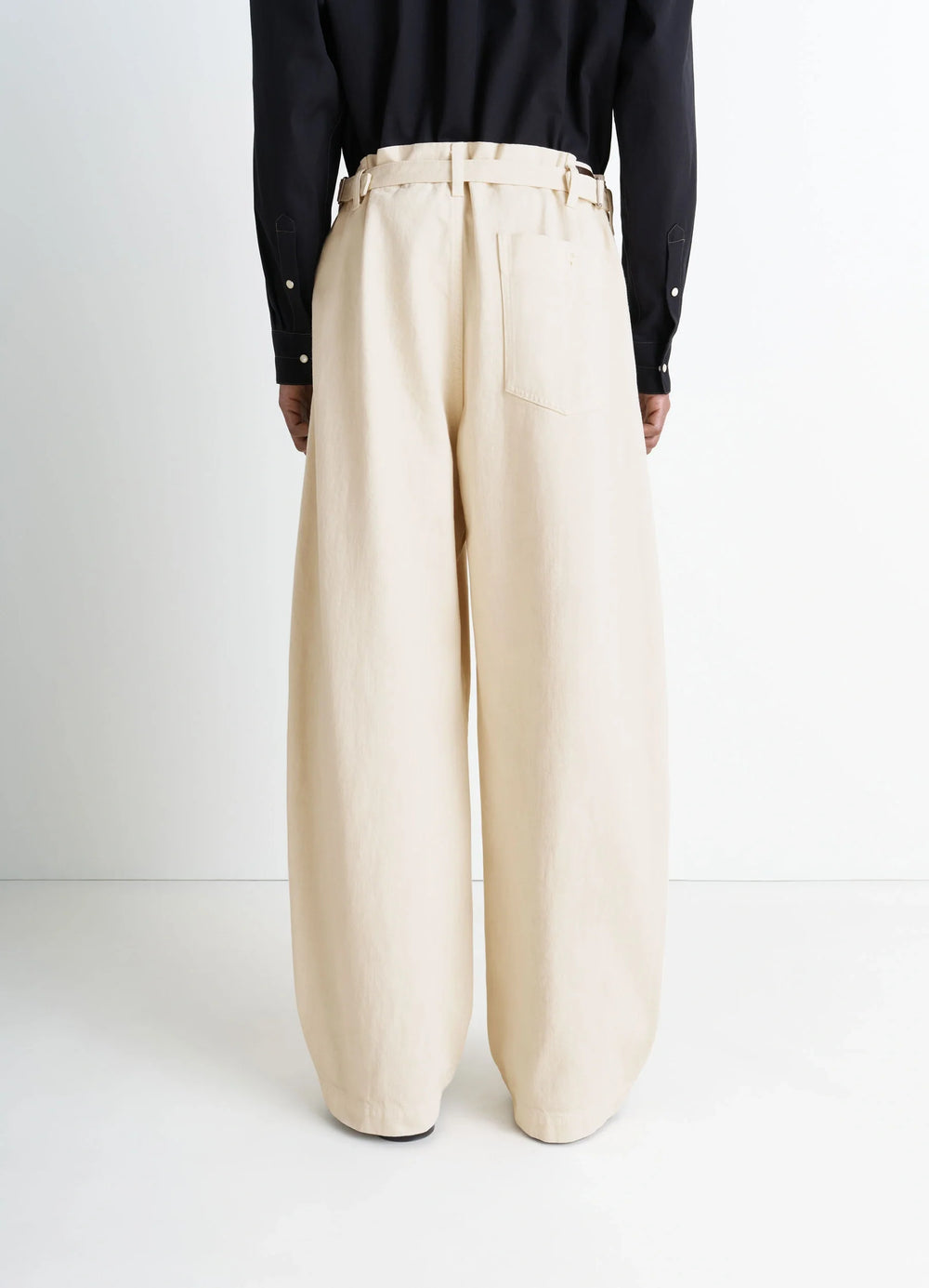 Lemaire Maxi Workwear Pants in Heather Garment Dyed Denim, model shot, back full body view wide leg relaxed fit