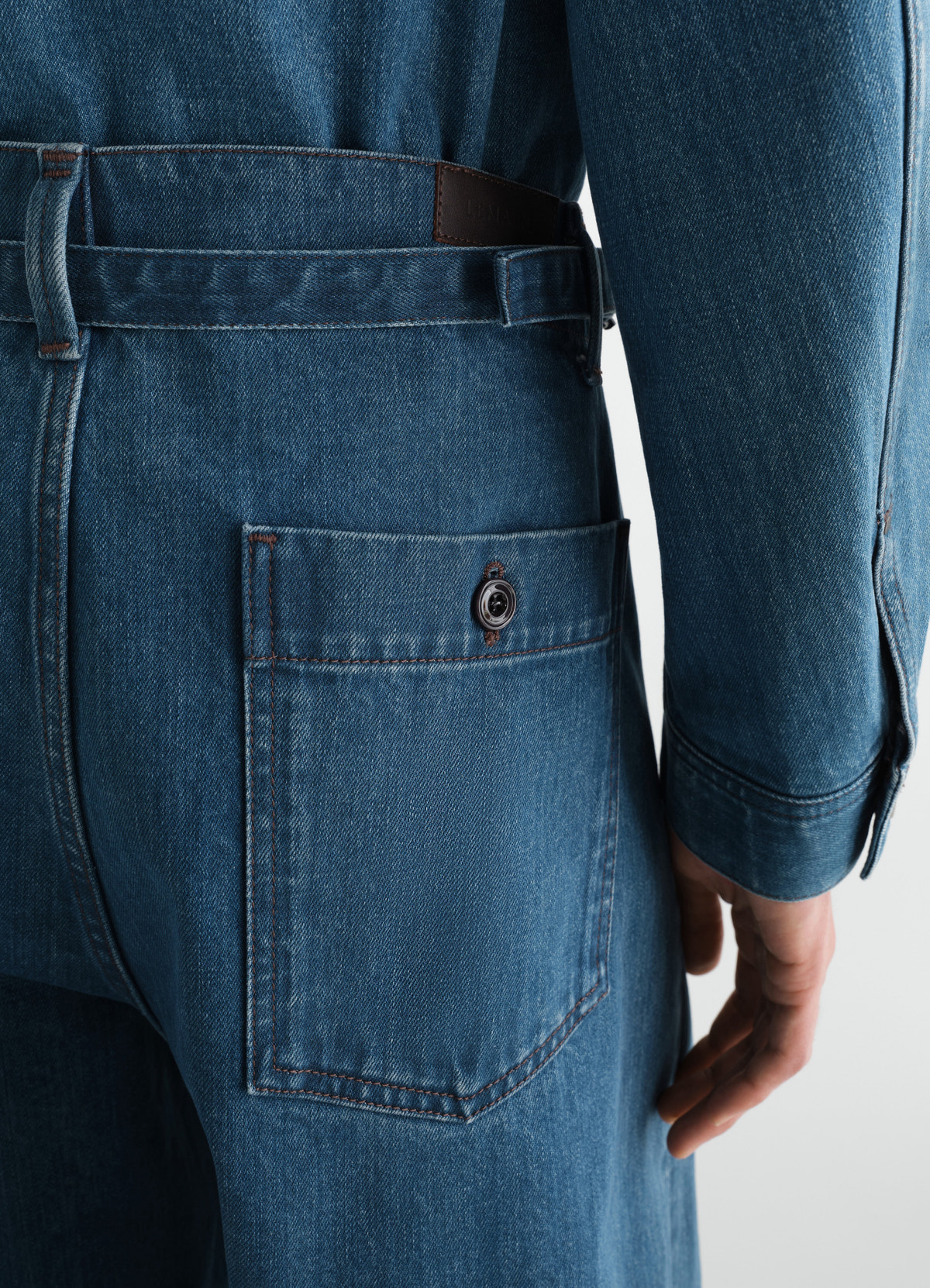 Oversized indigo selvedge denim workwear pants by lemaire close-up back pocket worn by model
