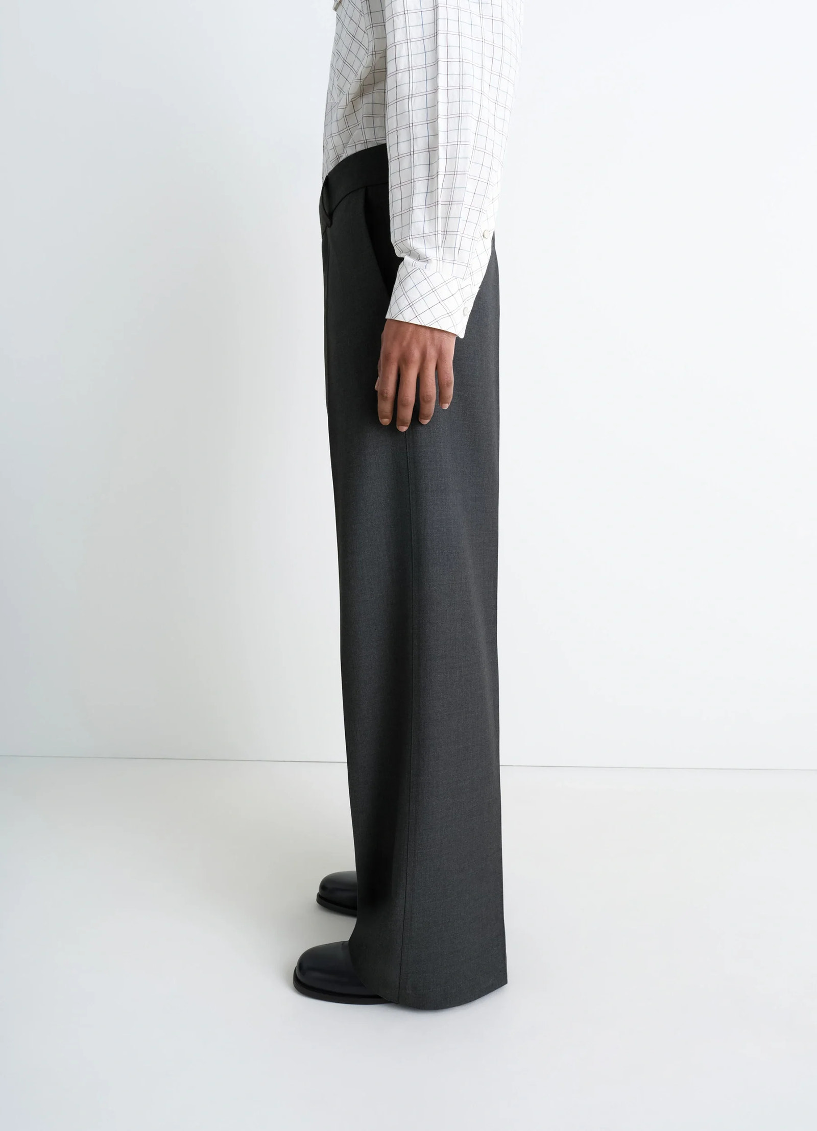 Lemaire straight tailored pants in grey wool-blend suit fabric, model shot, profile view wide leg hem detail