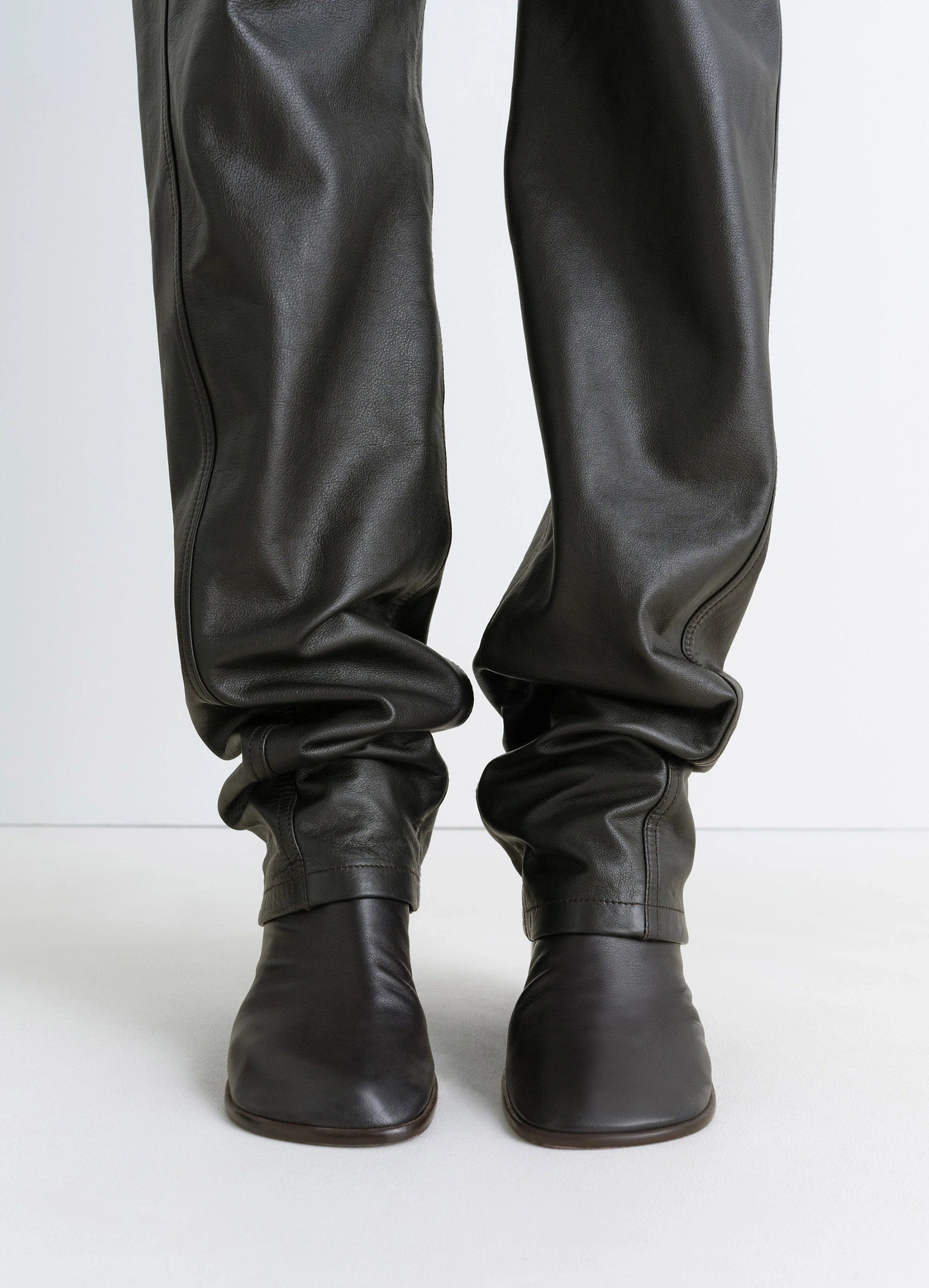 Lemaire leather five pockets twiste in nappa cow leather, product shot, detail shot gathered ankles with boots