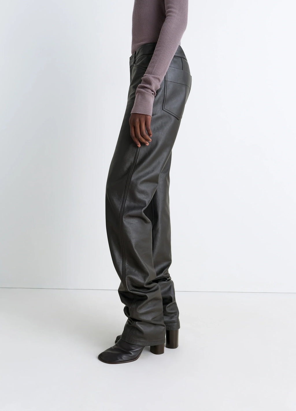 Lemaire Leather Five Pockets Twiste in Nappa cow leather, model shot, side view slouchy fit over boots