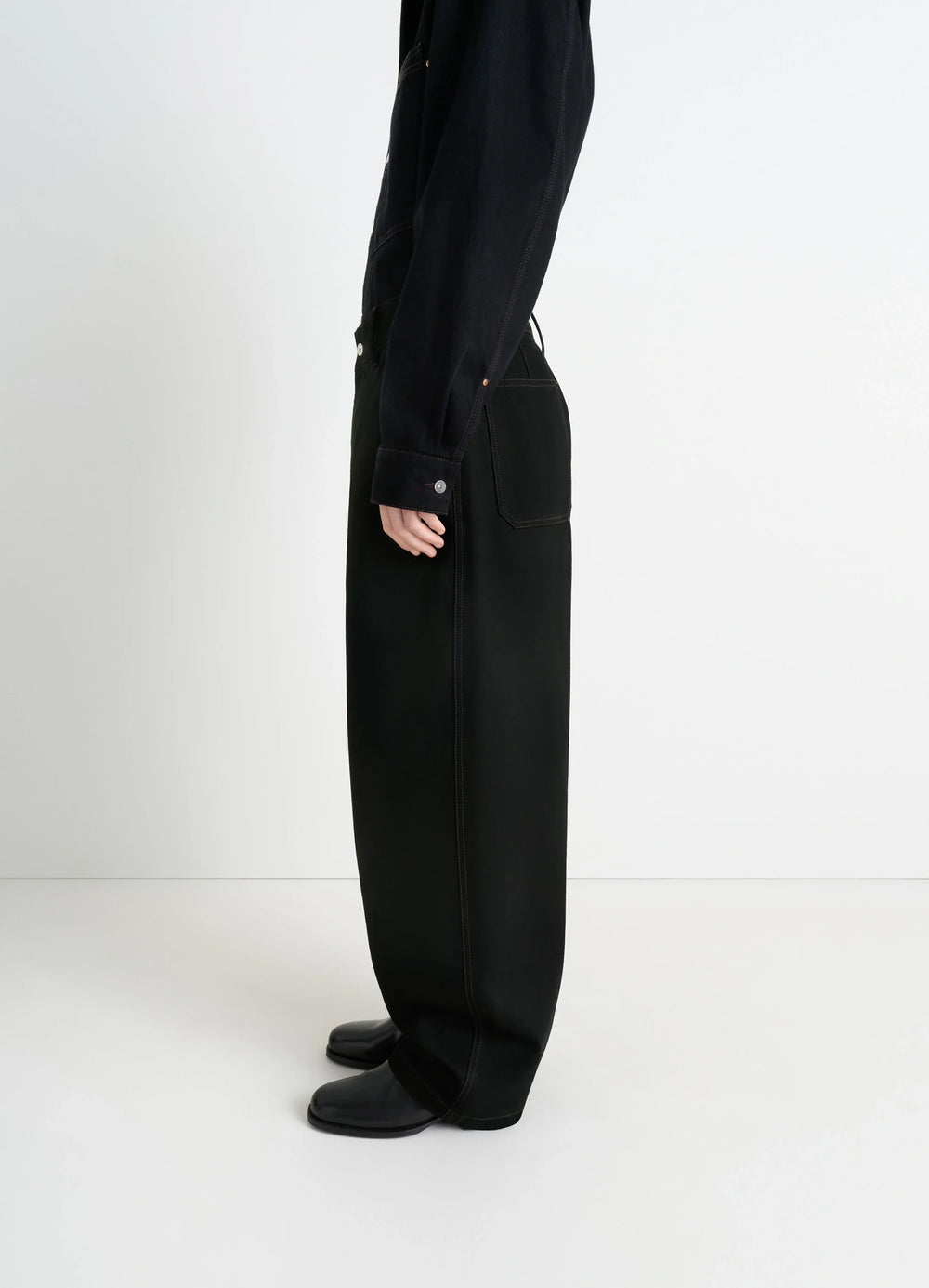 Lemaire Maxi Barrel Workwear Pants in Deep Black Thick Denim, model shot, side view barrel-cut wide leg