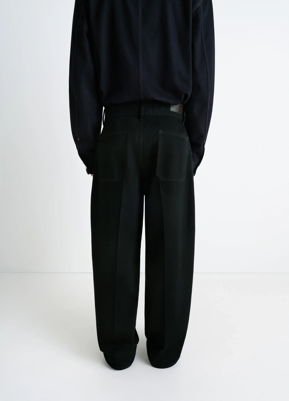Lemaire Maxi Barrel Workwear Pants in Deep Black Thick Denim, model shot, back full view straight oversized fit