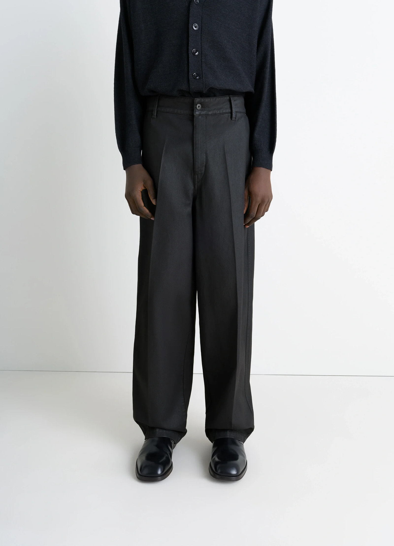 Lemaire maxi barrel workwear pants in glossy coated denim, model shot, lower body front view wide leg styling