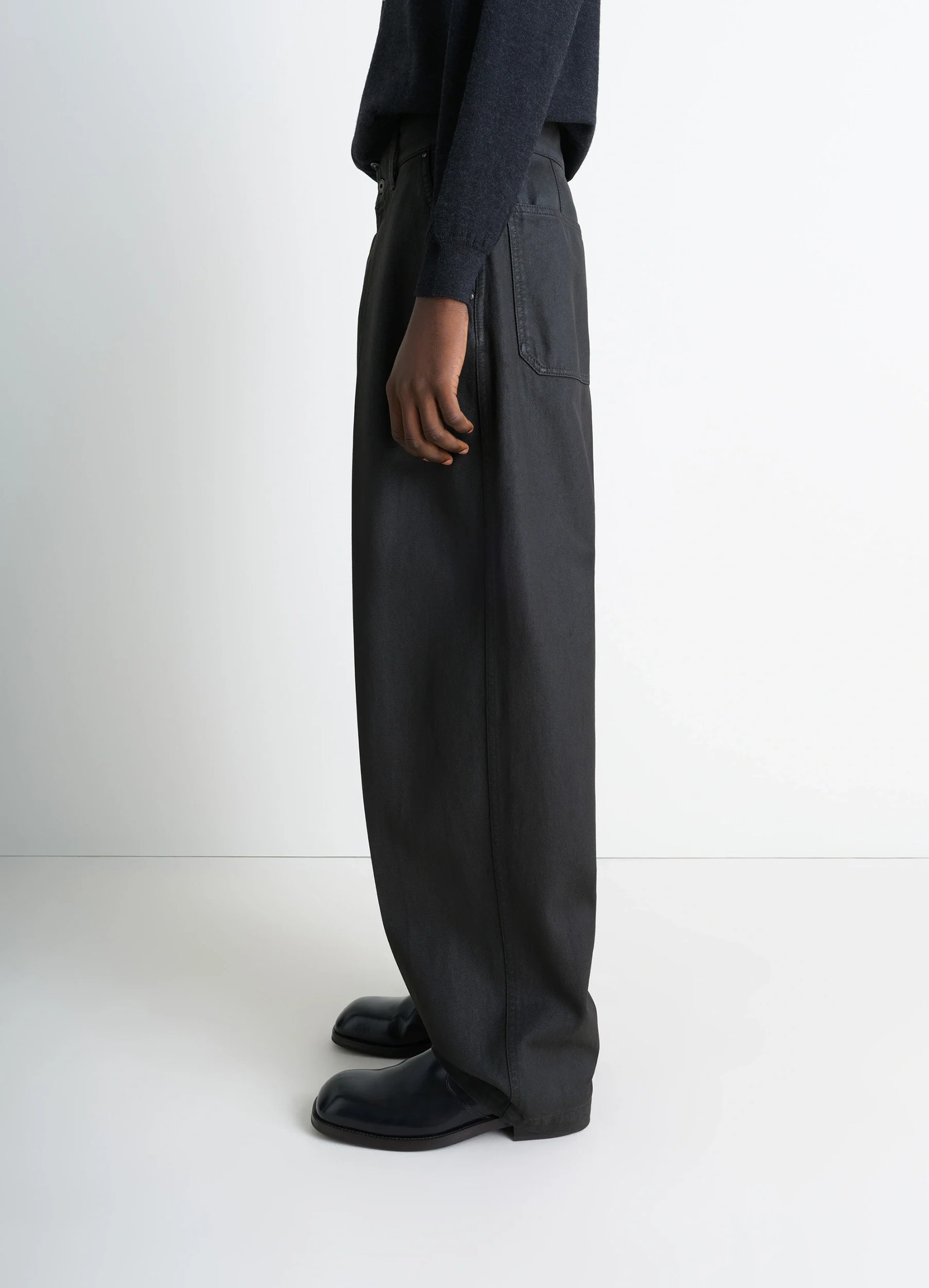 Lemaire maxi barrel workwear pants in glossy coated denim, model shot, side full-length view barrel cut silhouette