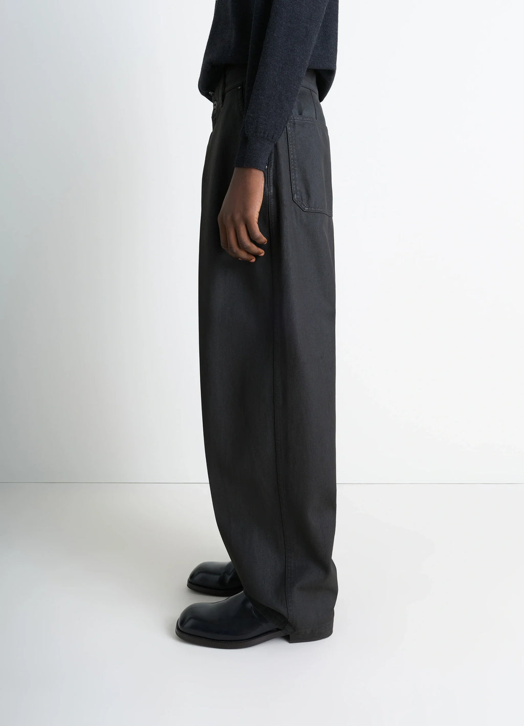 Lemaire Maxi Barrel Workwear Pants in Glossy Coated Denim, model shot, side full-length view barrel cut silhouette