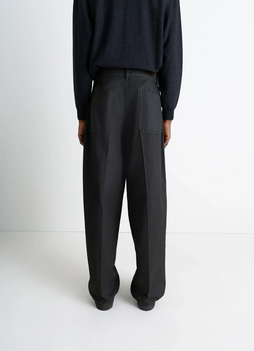 Lemaire Maxi Barrel Workwear Pants in Glossy Coated Denim, model shot, back view straight leg