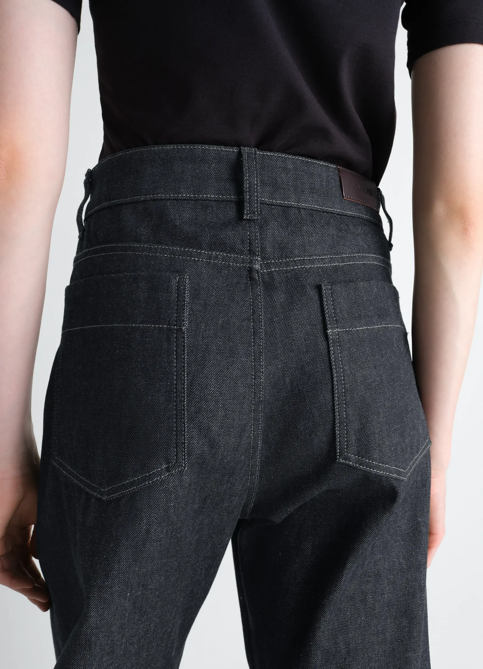 Lemaire high waisted curved pants in slate denim, model shot, back view high waist pocket detail