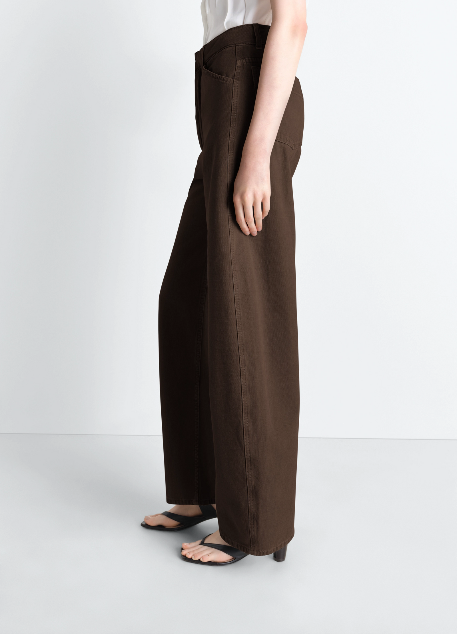 High waisted curved pants in dyed heavy broken twill, model shot, side view wide leg profile