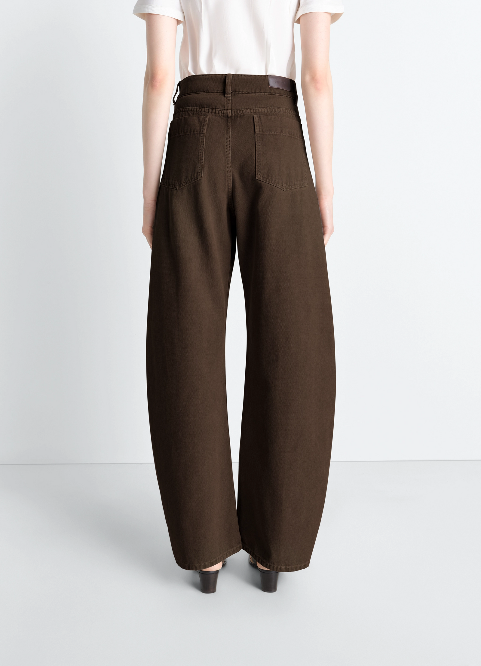 High waisted curved pants in dyed heavy broken twill, model shot, back view rear pocket detail