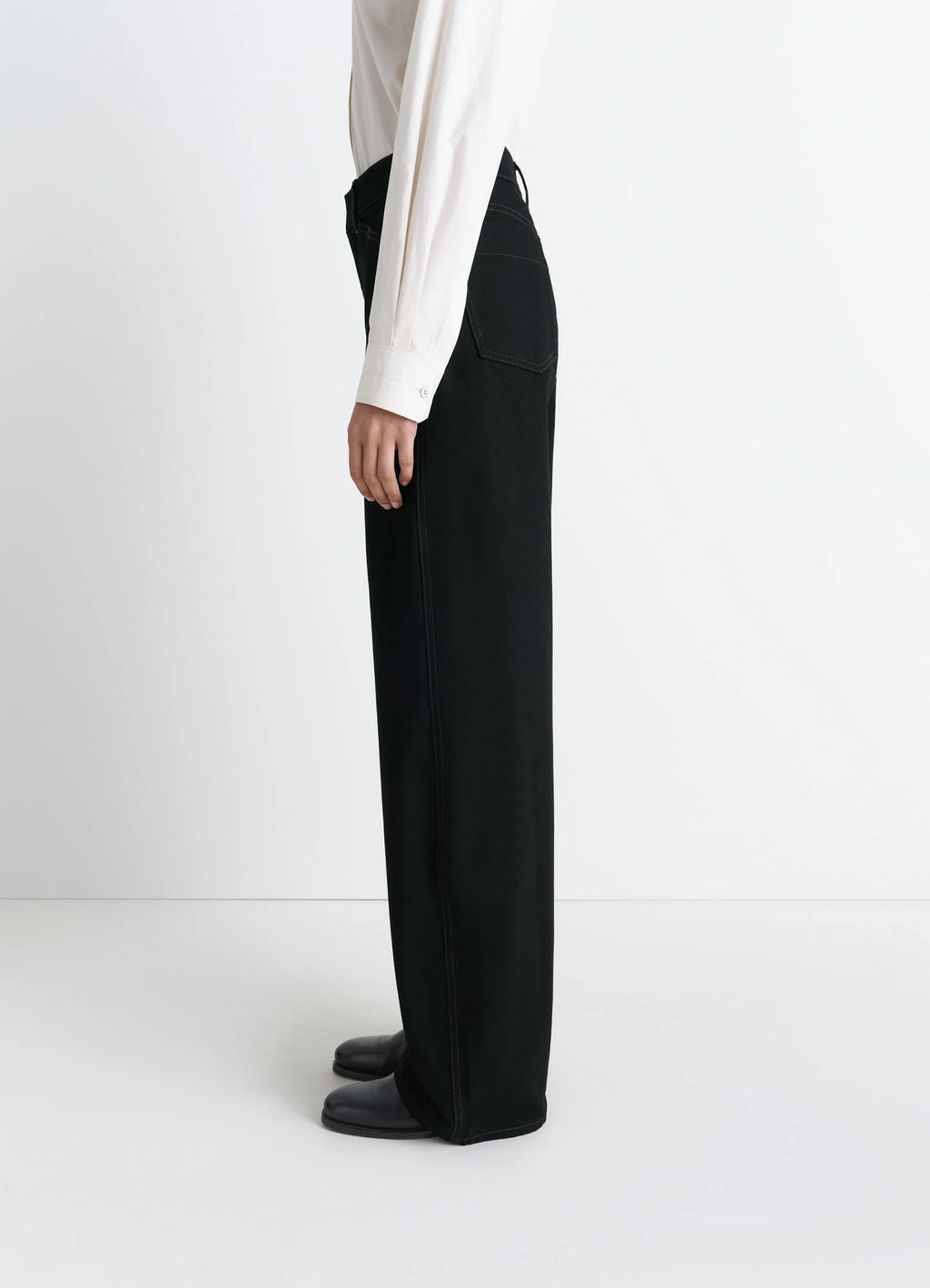 Lemaire High Waisted Curved Pants in Deep Black Thick Denim, model shot, side view high waisted structured leg