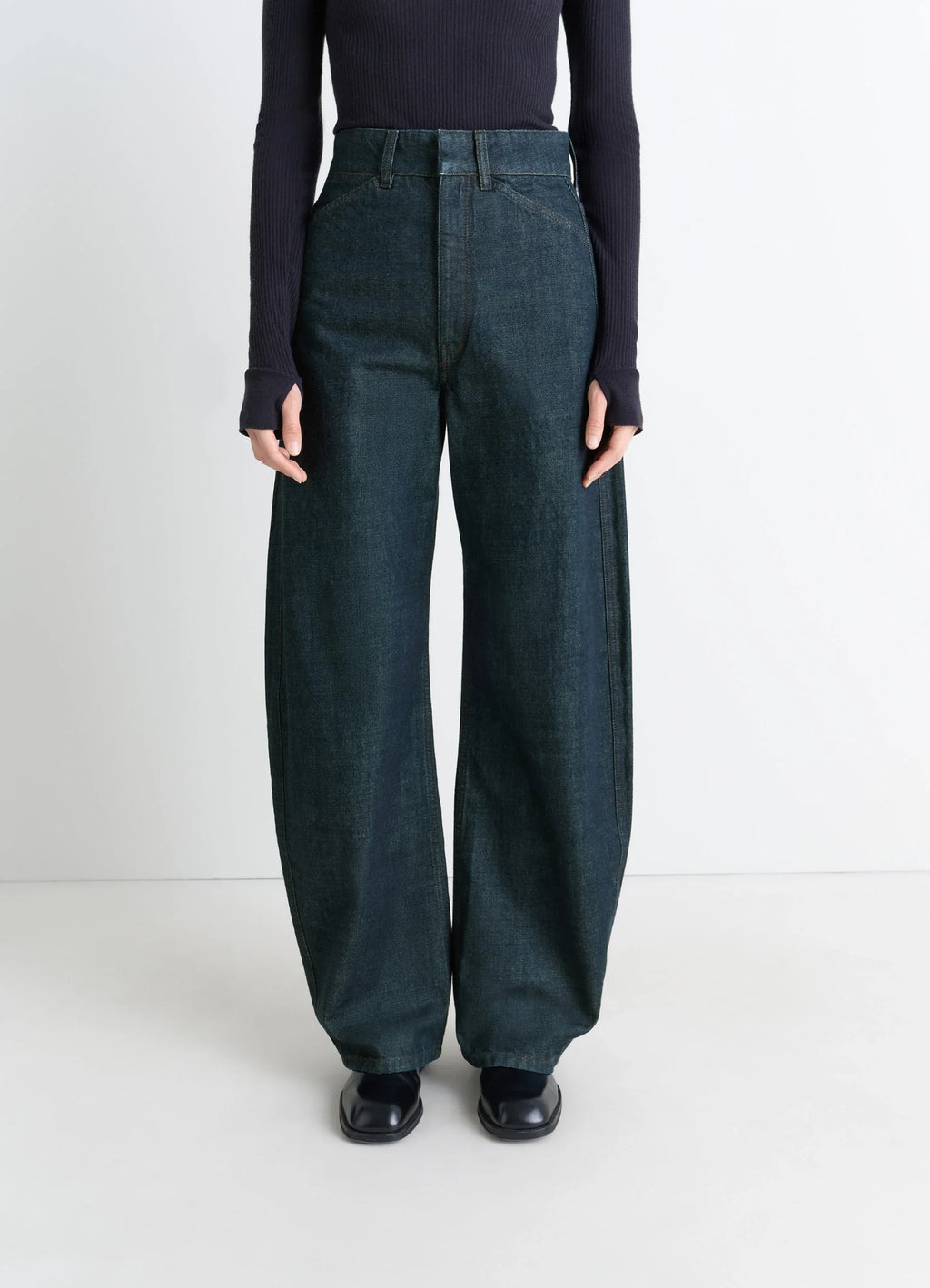 Lemaire High Waisted Curved Pants in Deep Indigo Thick Denim, model shot, porte waist-down view high waist curved silhouette