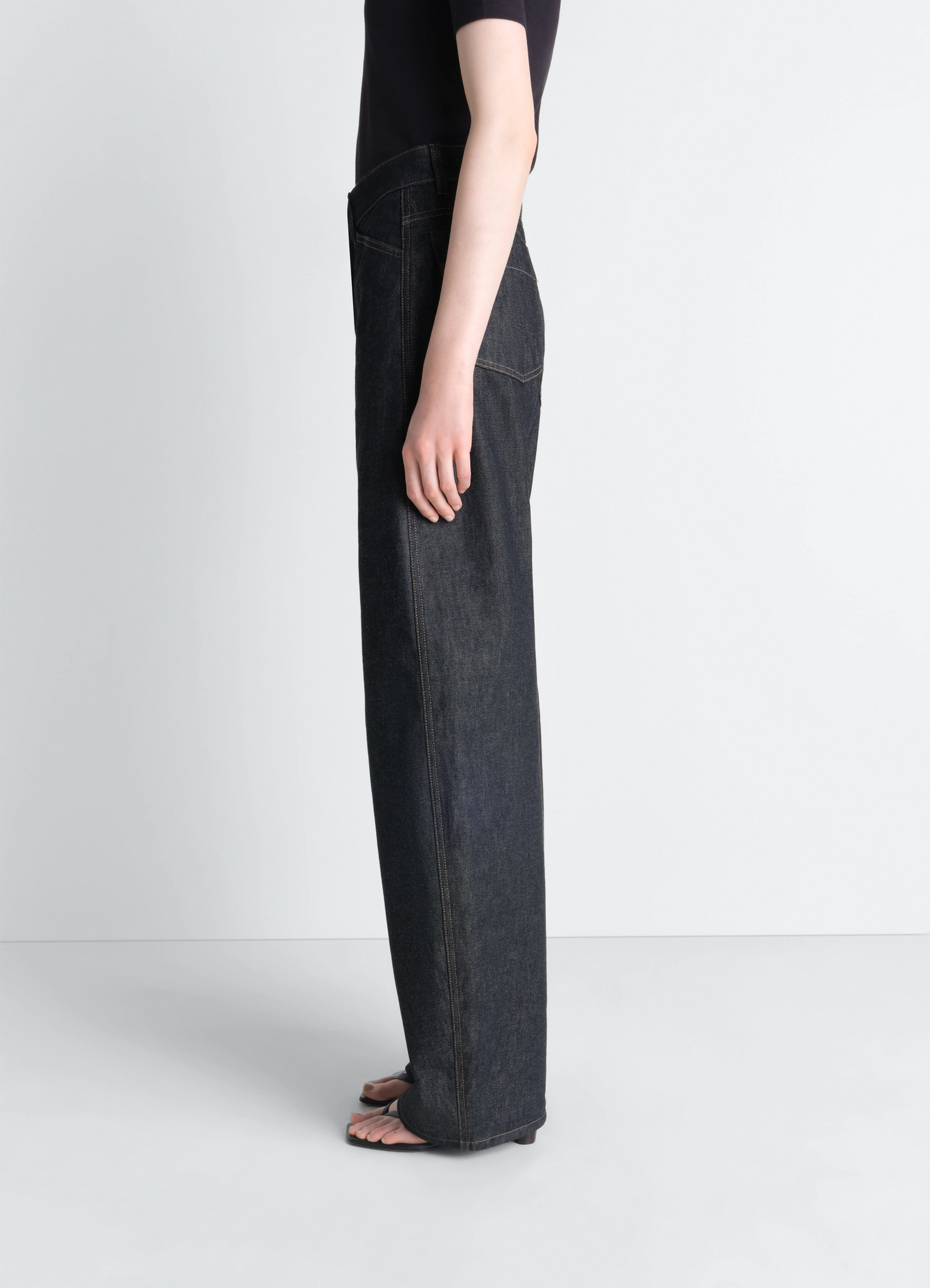 Lemaire high waisted curved pants in slate denim, model shot, side view wide leg silhouette