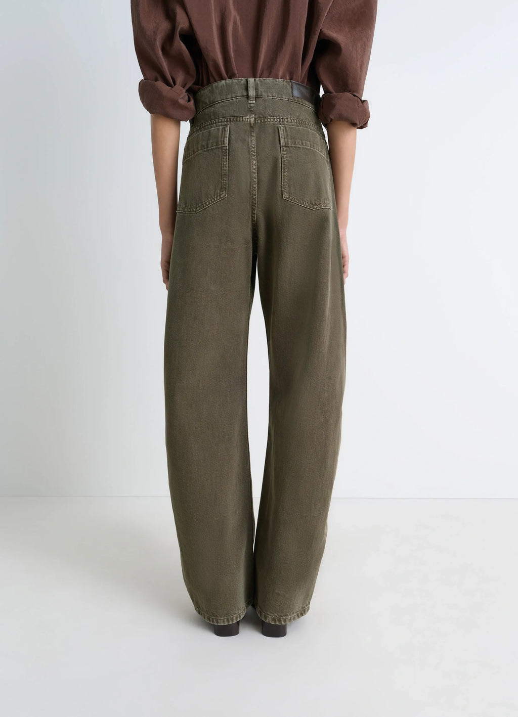 Lemaire High Waisted Curved Pants in Heather Garment Dyed Snow Denim, model shot, back view double back pockets and high wais