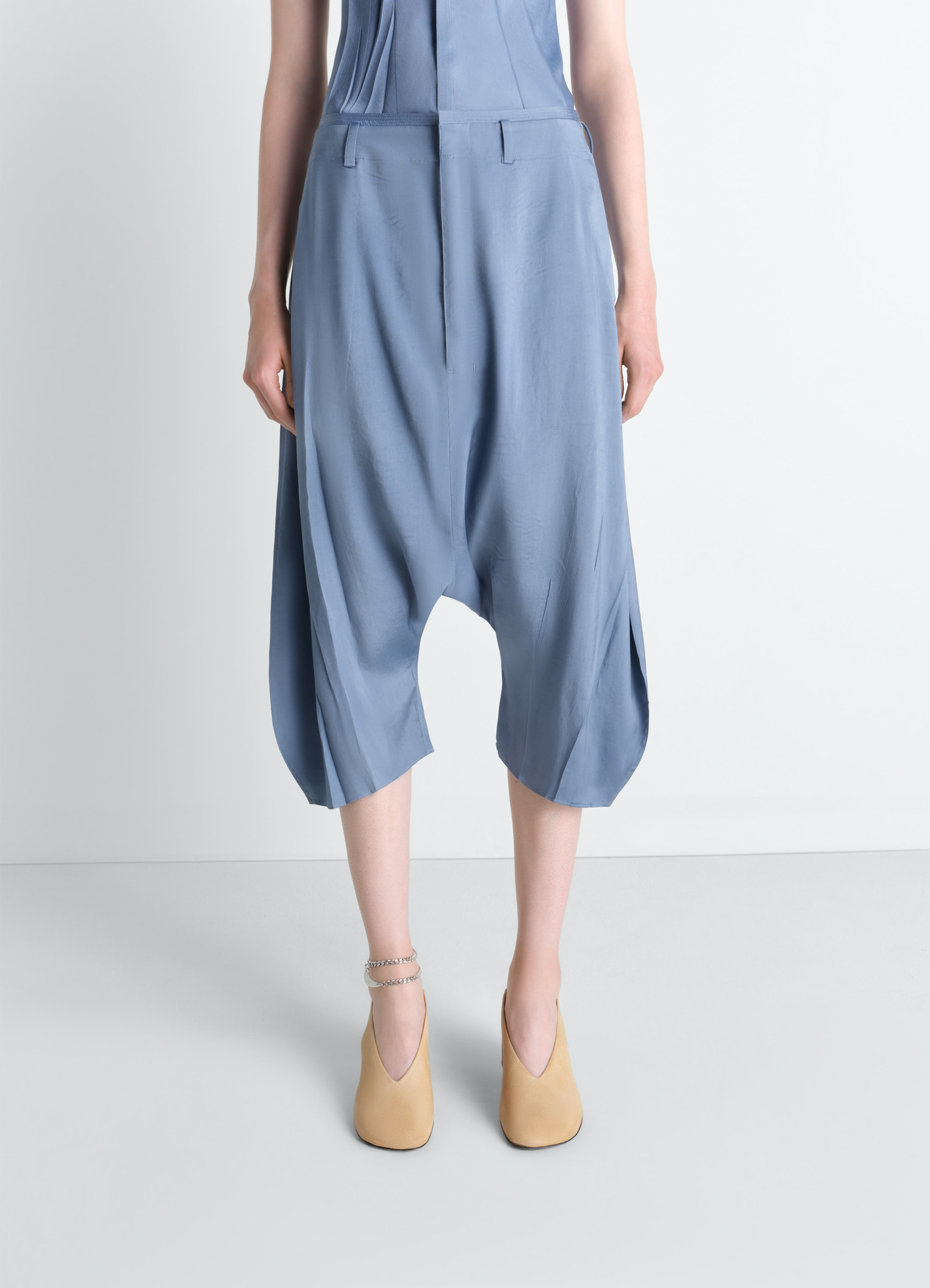 Creased dropped crotch bermudas in poly viscose twill, model shot, back view creased texture, dropped crotch