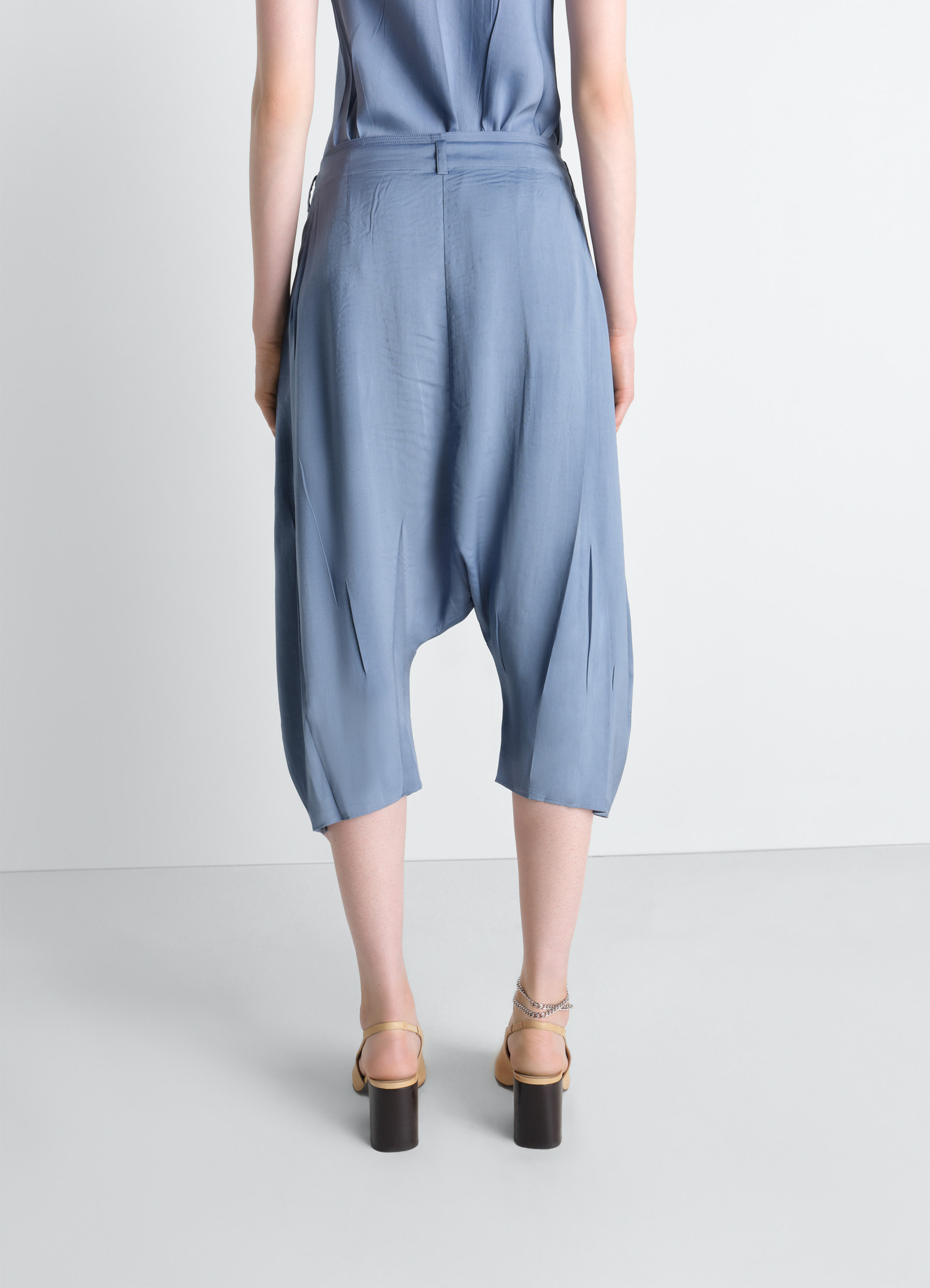 Creased dropped crotch bermudas in poly viscose twill, model shot, back close-up view creased, high rise, relaxed fit