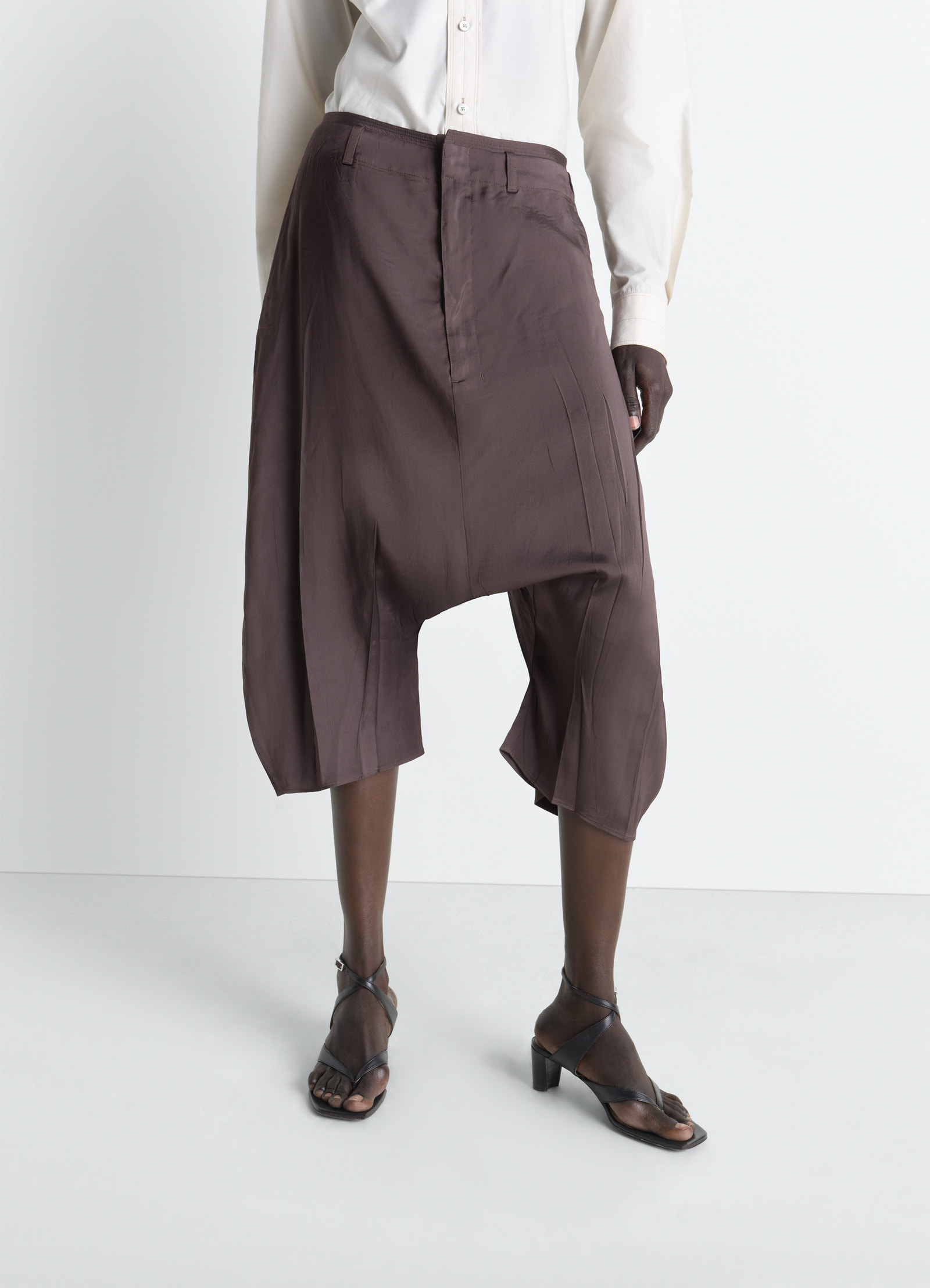 Creased dropped crotch bermudas in poly viscose twill, model shot, side view creased dropped crotch