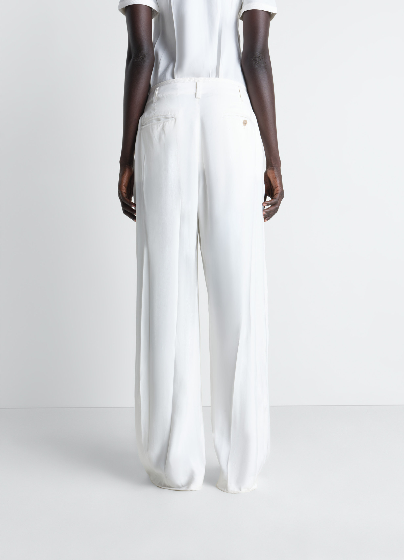 Creased soft pants in poly viscose twill, model shot, rear view loose fit hem detail