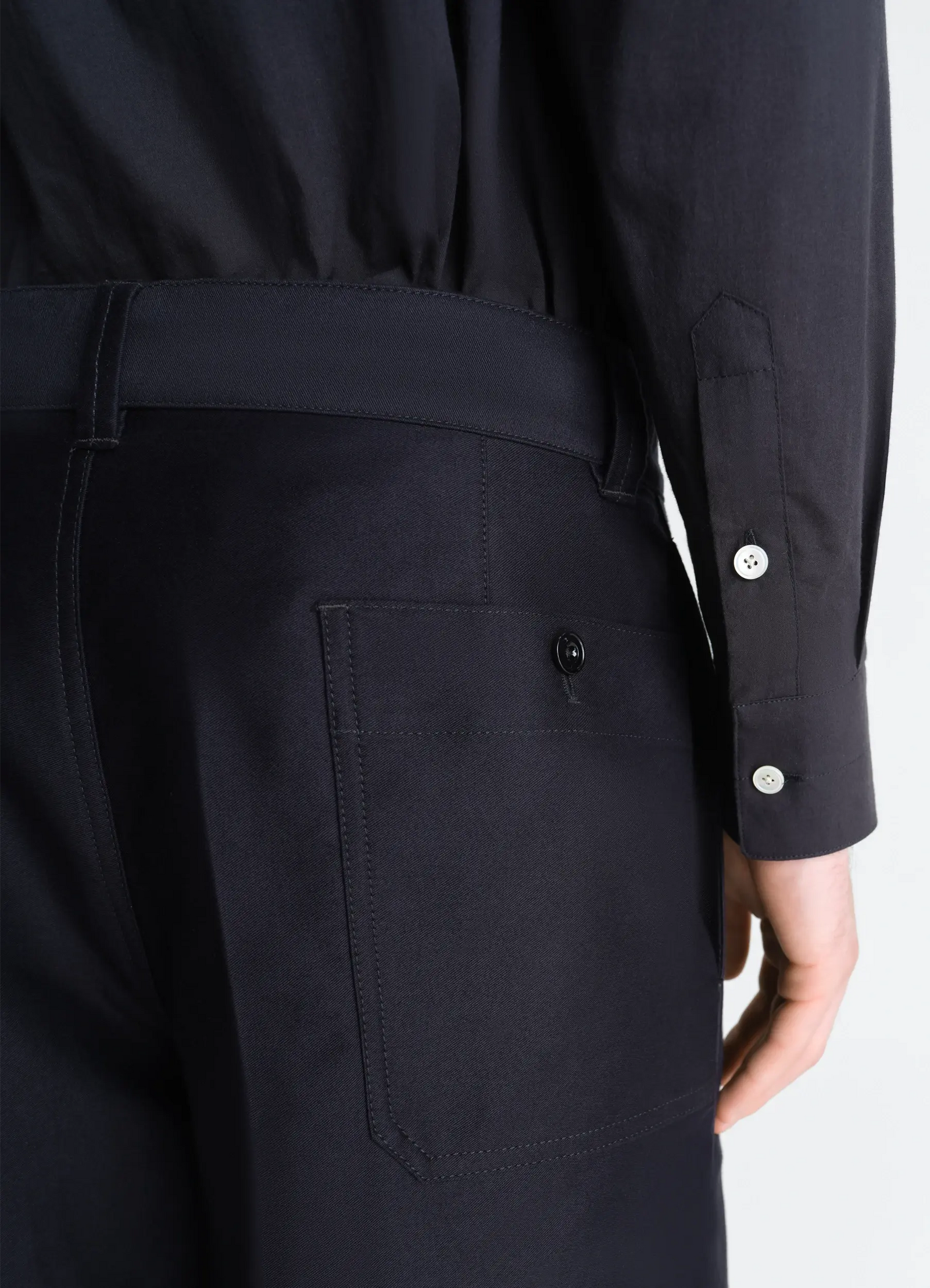 Lemaire wide workwear pants in cotton satin, model shot, back detail view wide leg visible pocket