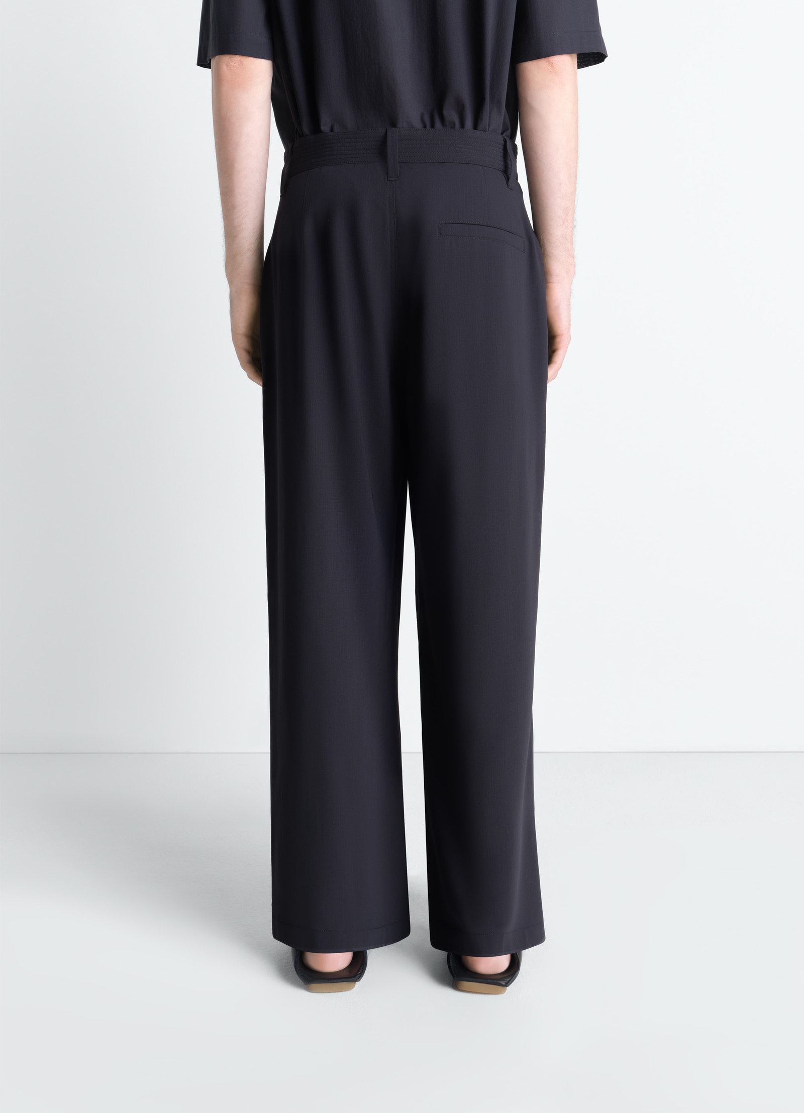 Single pleat pants in wool crêpe, model shot, back view wide leg with loafers