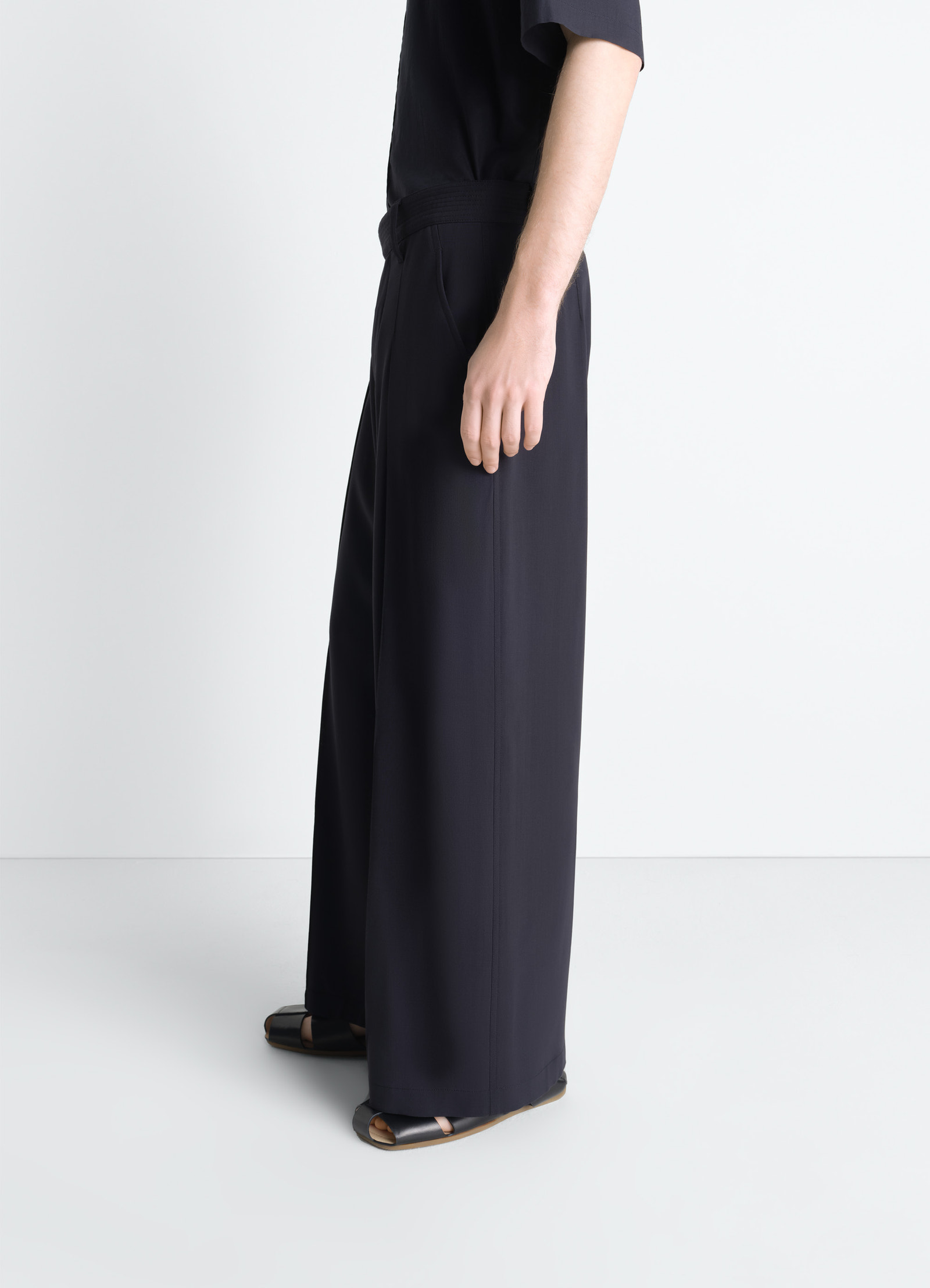 Single pleat pants in wool crêpe, model shot, side view wide leg with sandals