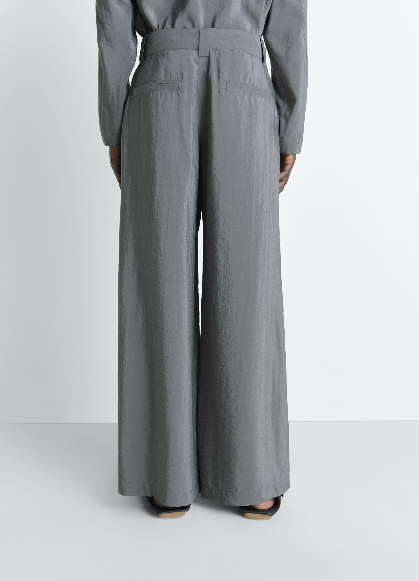 Straight tailored pants in dry silk, model shot, rear full-length view belted high waist