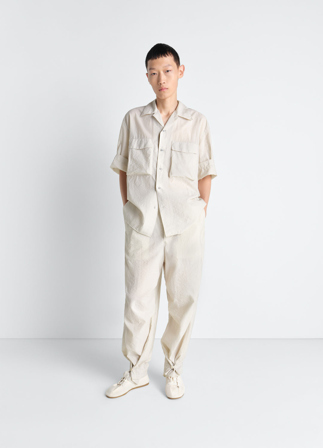 Lemaire Parachute Pants in Washed Technical Cotton, model shot, front view rounded leg adjustable hem