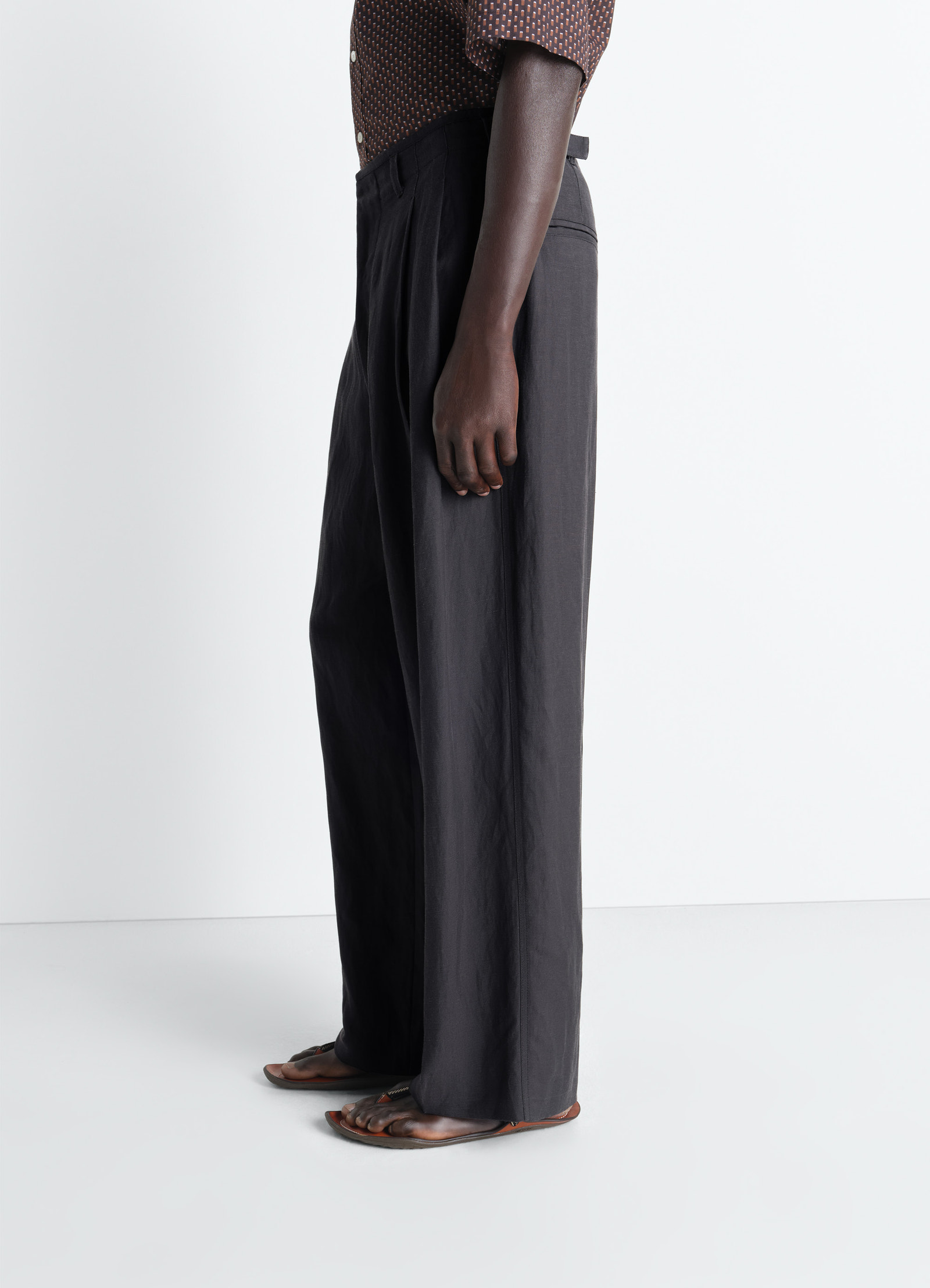 Pleated tailored pants in viscose linen gabardine, model shot, side lower body view straight hem fold