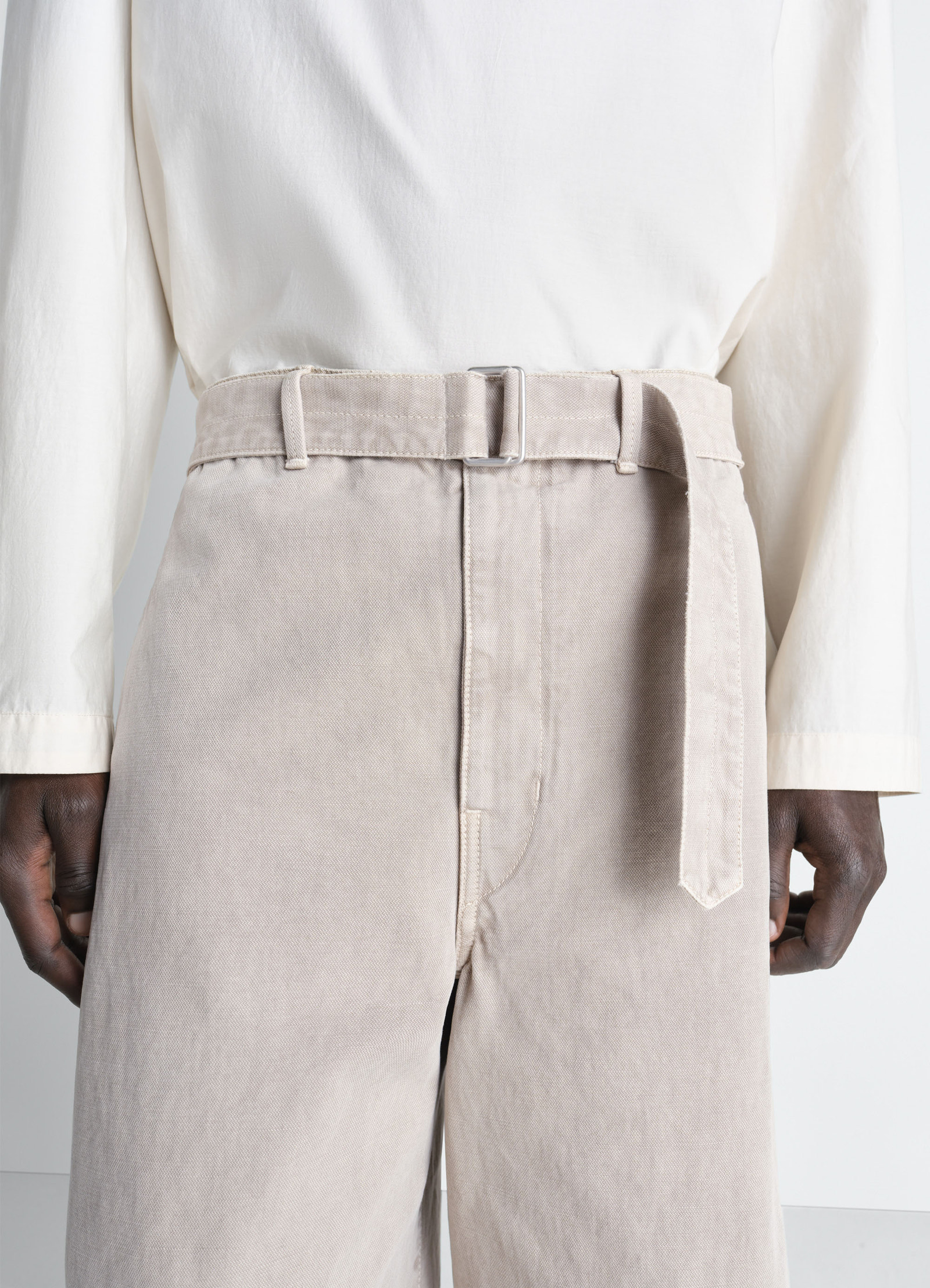 Denim short in heavy broken twill in snow, model shot, detail shot belted waist close-up